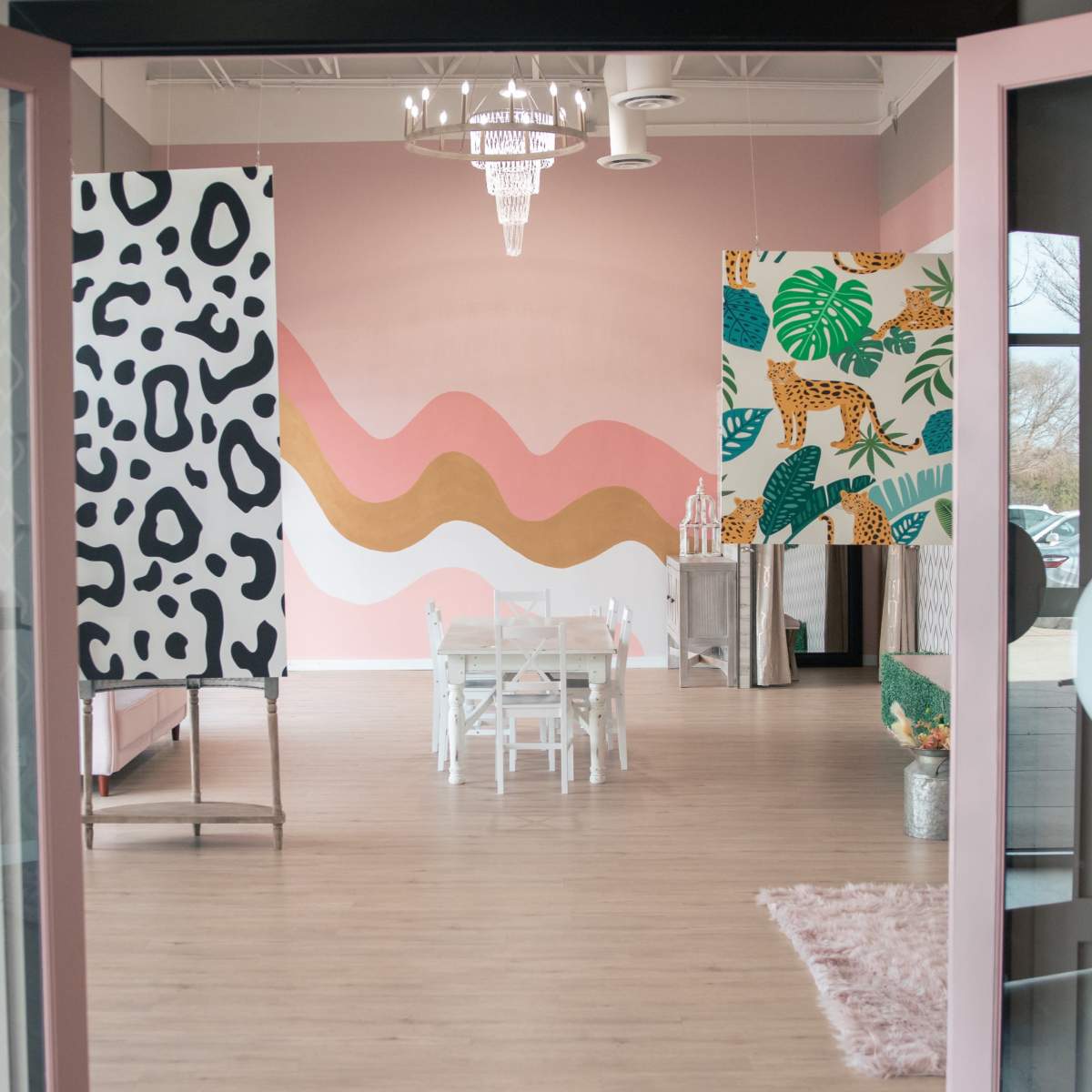 A brightly decorated interior space featuring colorful walls and stylish decor, with a small table and chairs in the center.