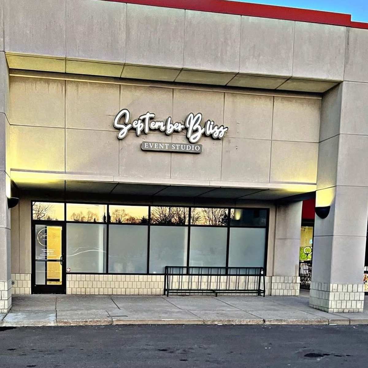 The exterior of a building featuring a sign that reads "September Bliss Event Studio."
