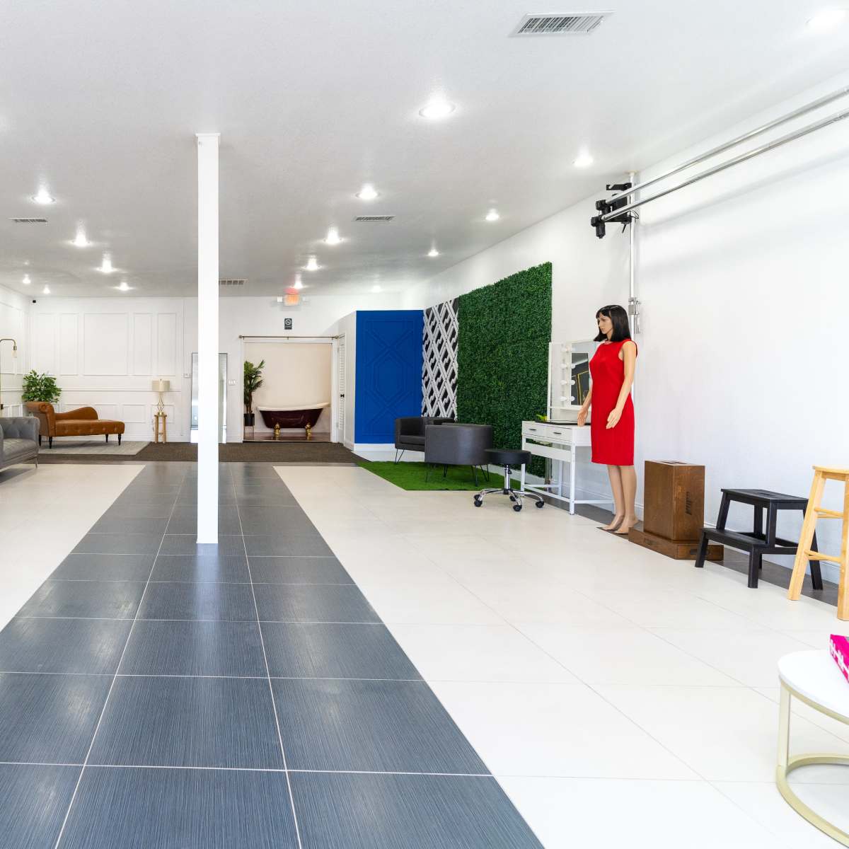 A spacious, modern interior with a mix of seating areas, colorful walls, and various decorative elements.