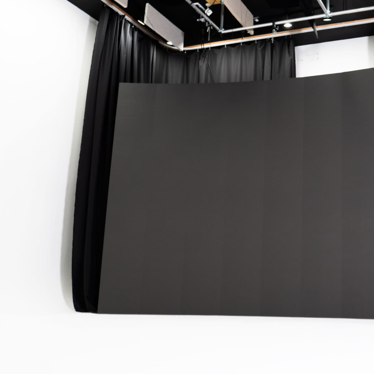 A large, curved black backdrop in a photography studio.