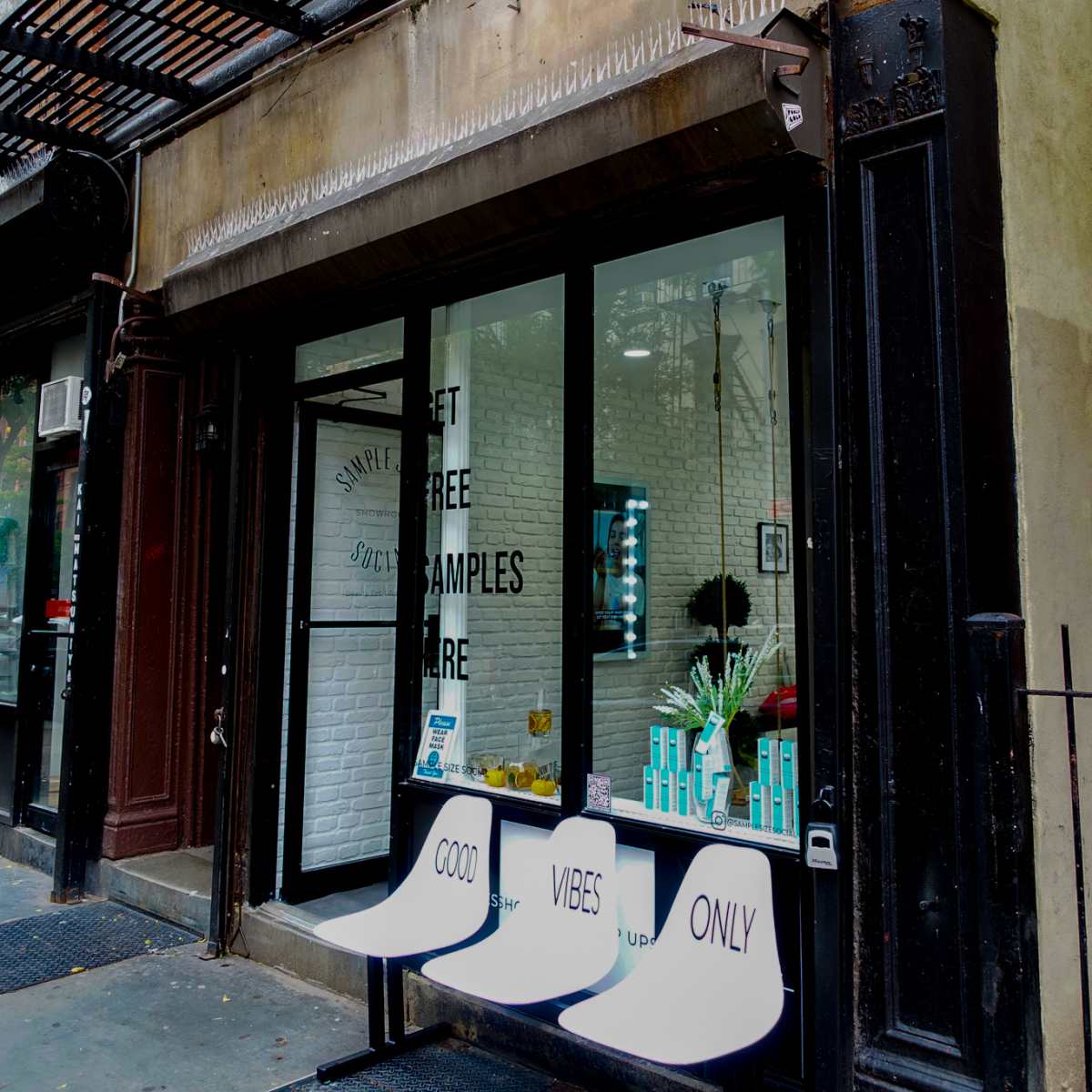 A storefront with a sign reading "Sample Social" features a seating area displaying the text "GOOD VIBES ONLY."