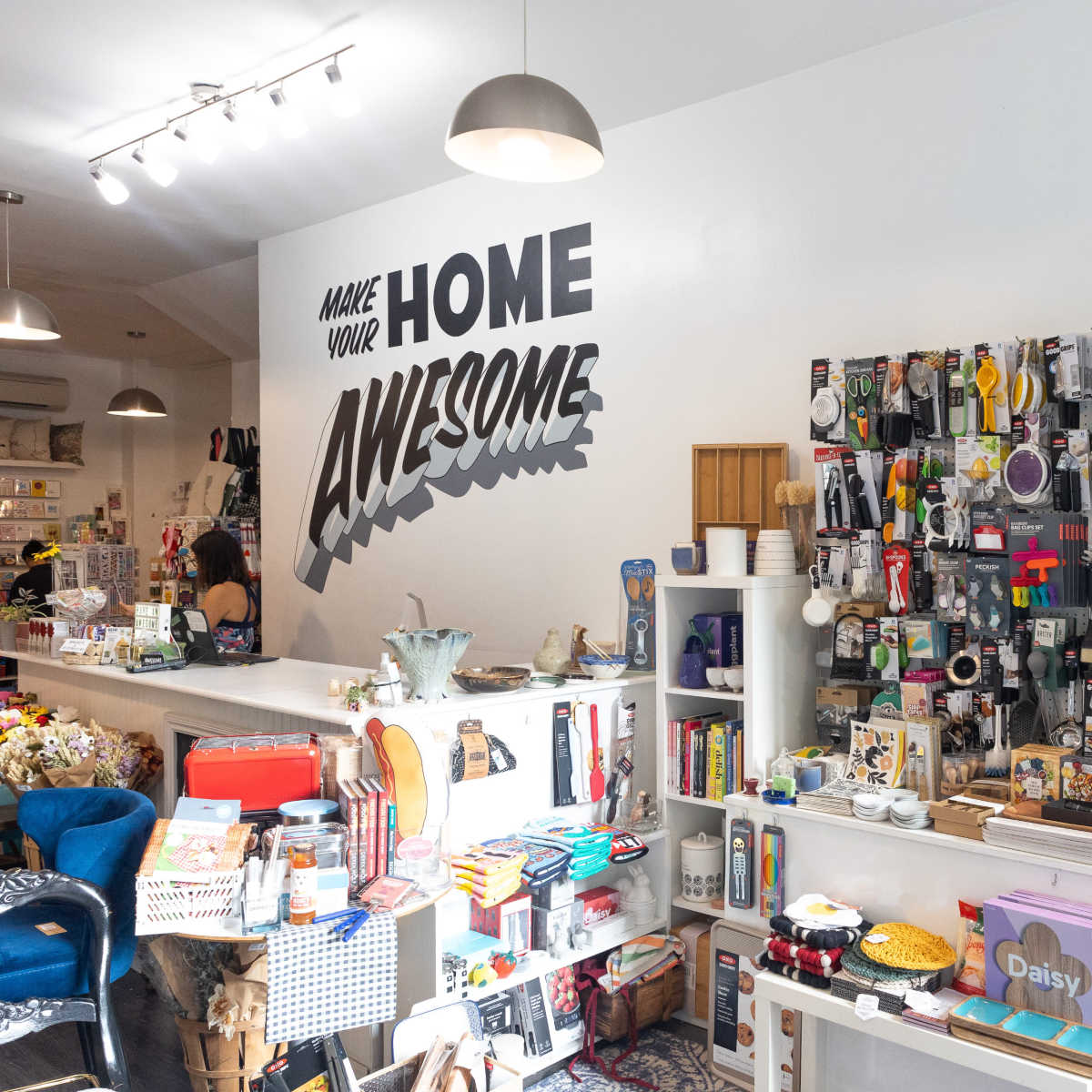 A vibrant home goods store with various merchandise and a wall featuring the phrase "Make Your Home Awesome."