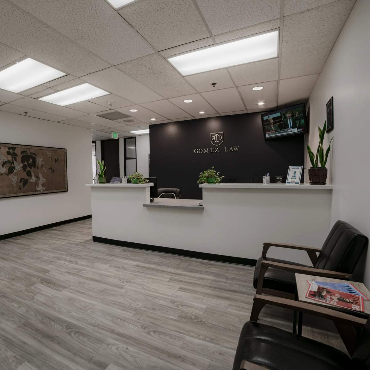 A law office reception area with a desk, seating for clients, and modern decor.