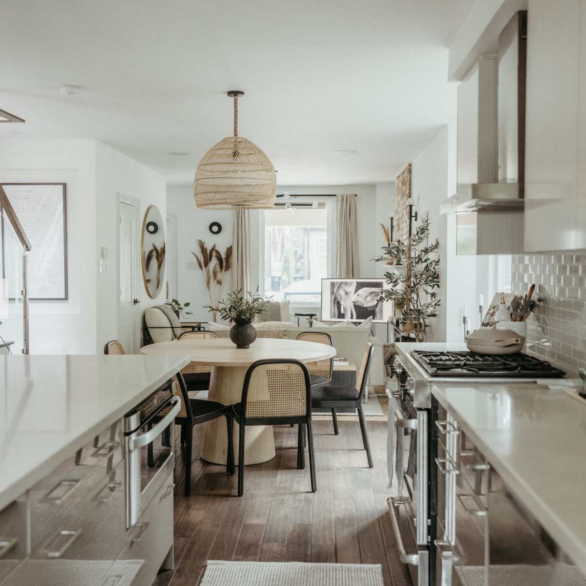 The kitchen features modern cabinetry, a spacious dining area, and large windows that provide natural light.