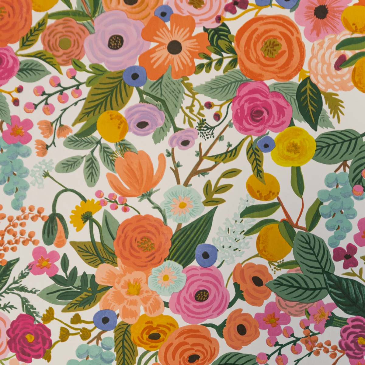 A colorful floral pattern with a variety of flowers, leaves, and berries arranged densely on a white background.