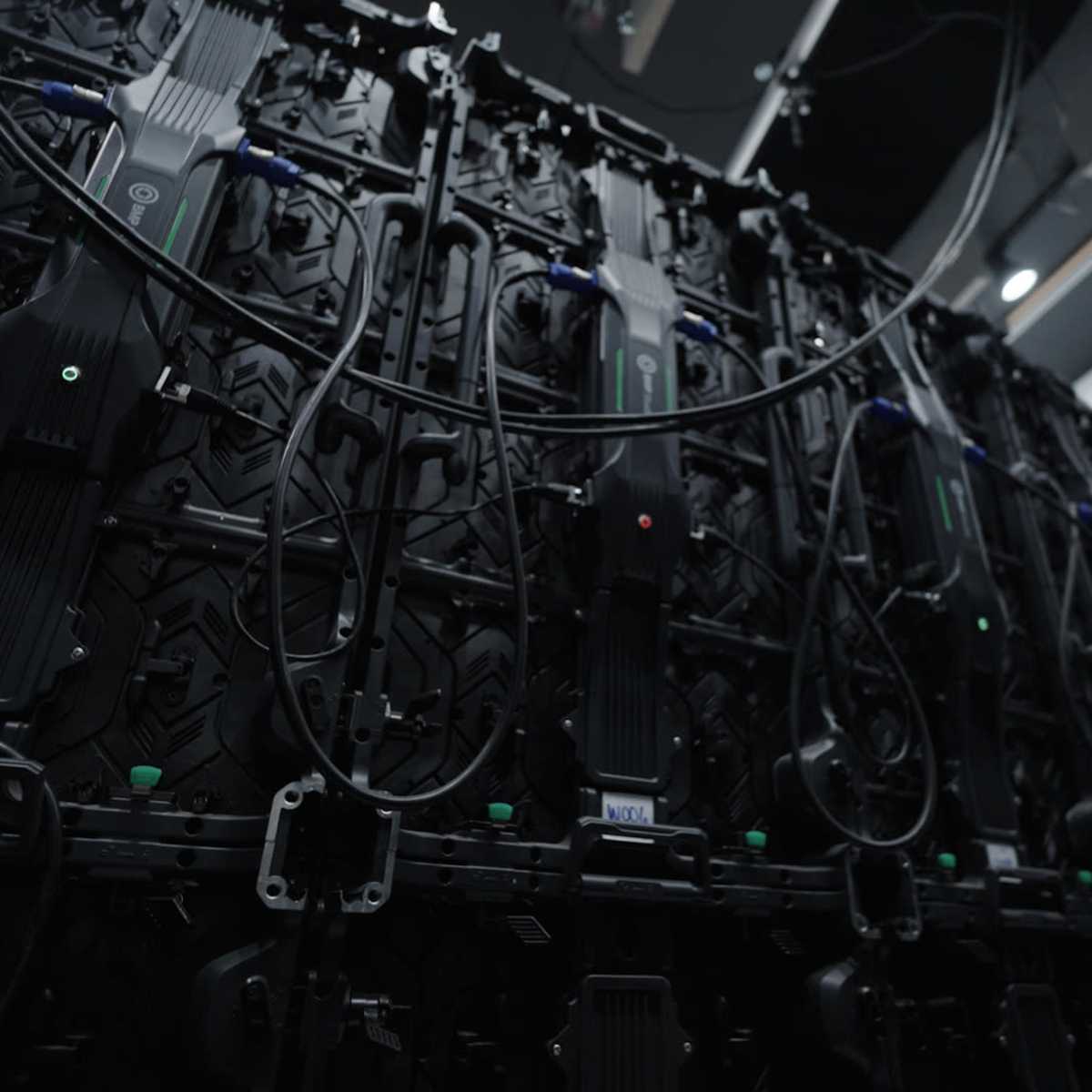 A large wall of interconnected display panels with various cables and connectors visible.