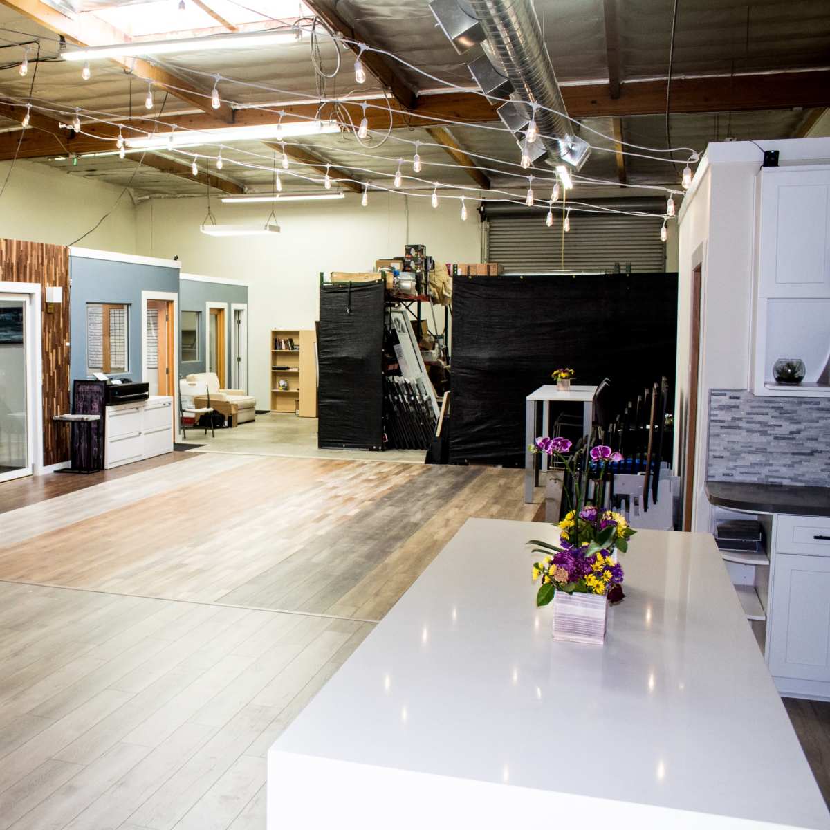 A spacious, well-lit interior of a modern workshop or studio with wooden accents and an open layout.