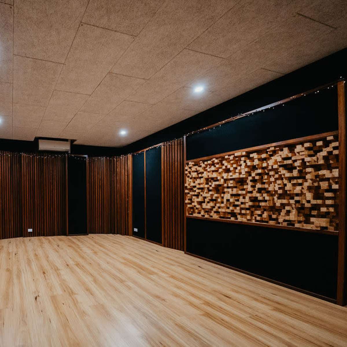 A spacious, well-lit recording studio with wooden paneling and soundproofing features.