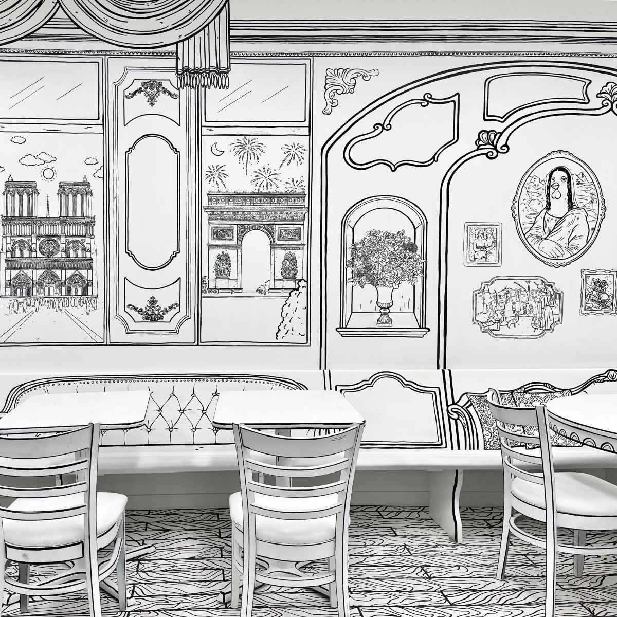A cafe interior with white tables and chairs, adorned with black line art illustrations on the walls depicting various architectural landmarks and decorative elements.
