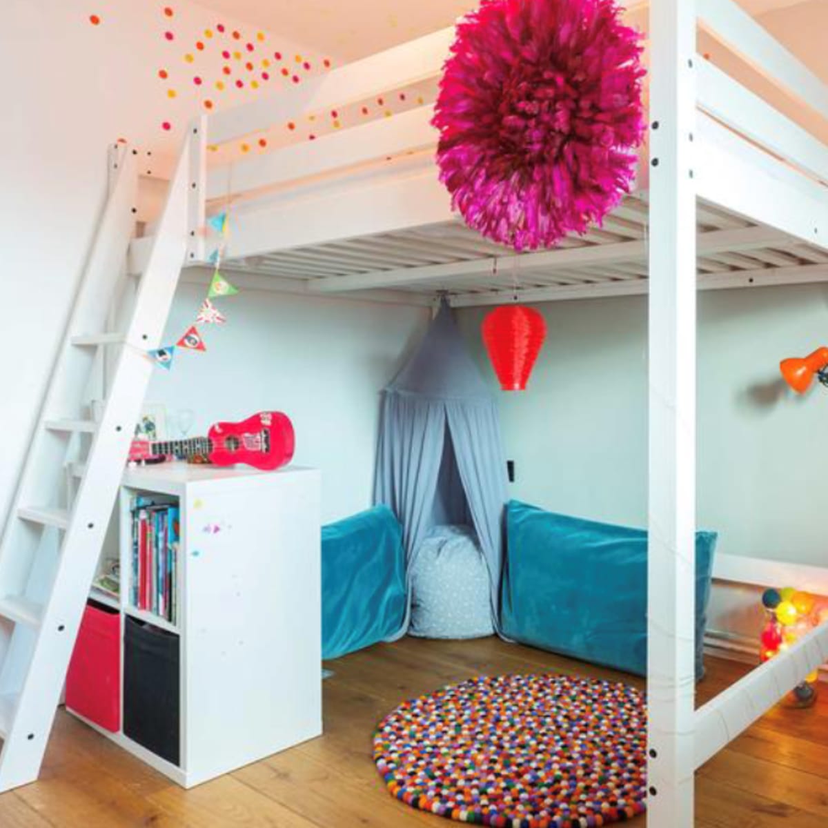 A modern children's bedroom featuring a loft bed, two lower beds, colorful decorations, and a round rug on a wooden floor.