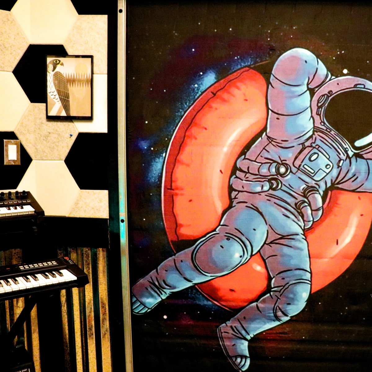 A mural of an astronaut floating in space against a red circular background.