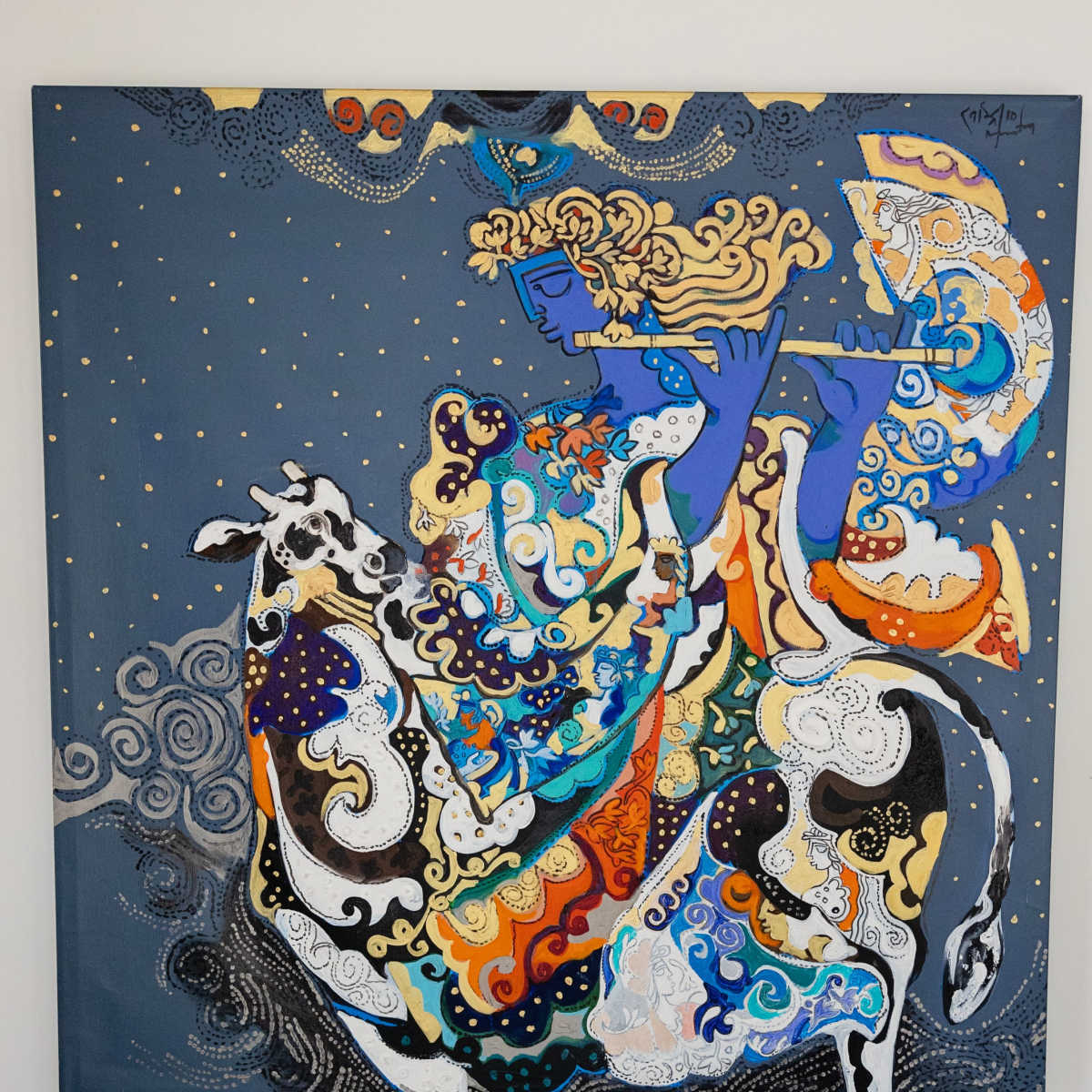 A colorful painting depicting a figure playing a flute while riding a decorated cow against a dark blue background.