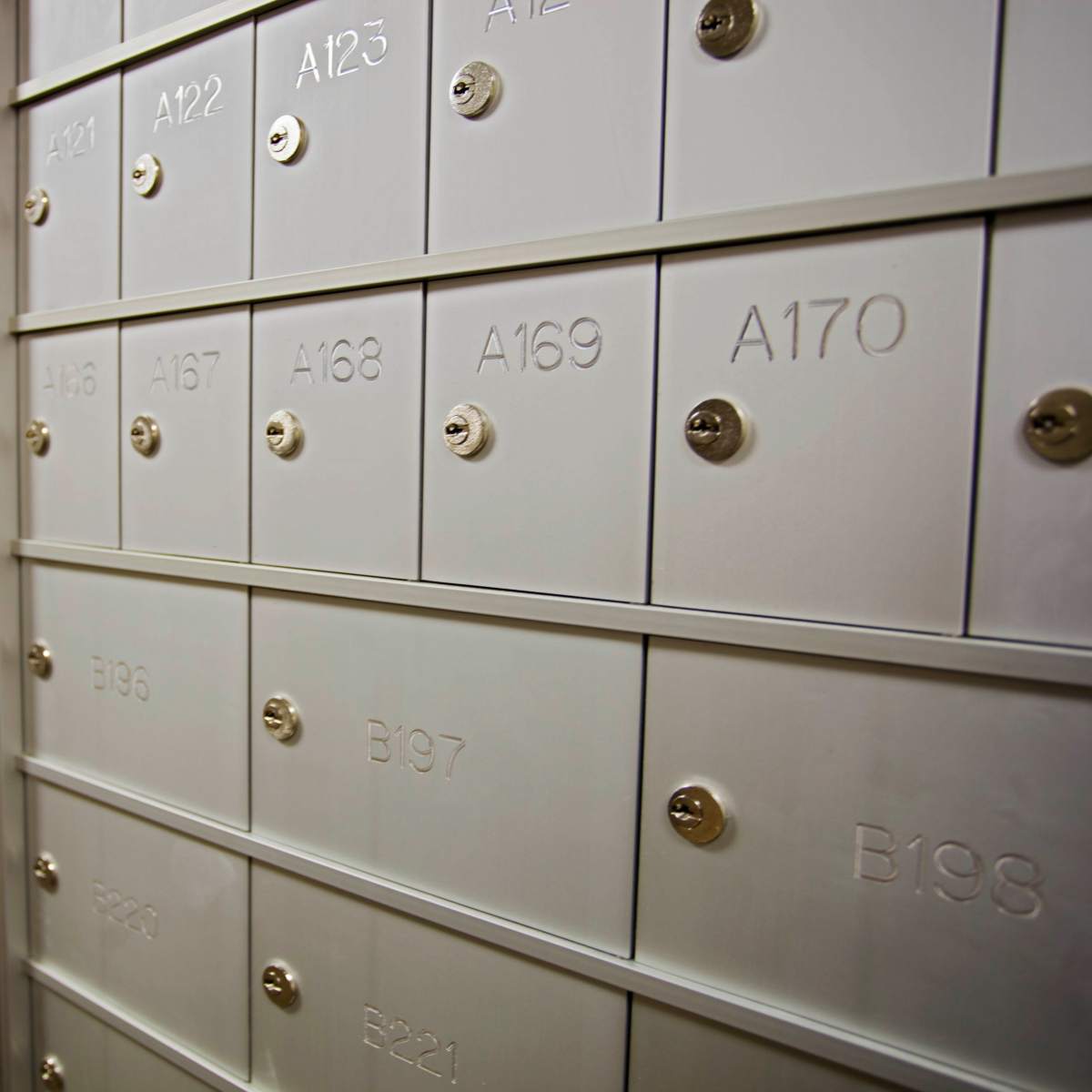 A row of metal mailboxes with numbered compartments.