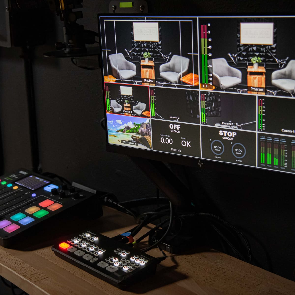 A multi-screen monitor setup displays various feeds and controls from a video production studio.