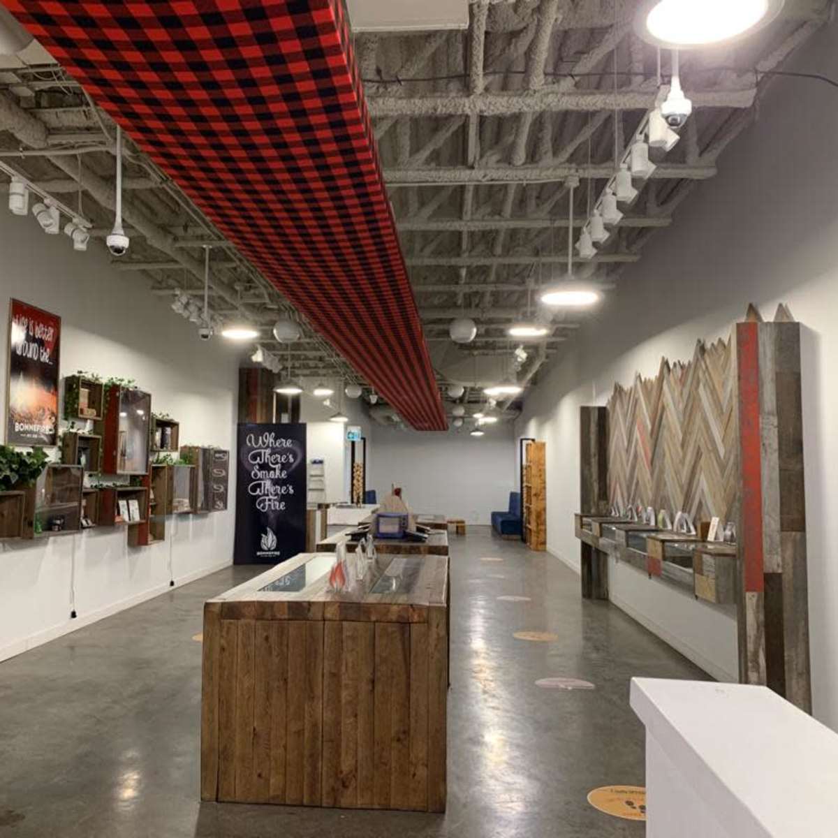 A spacious, modern interior with a long corridor featuring a wooden reception desk, wall-mounted displays, and decorative elements along the walls.
