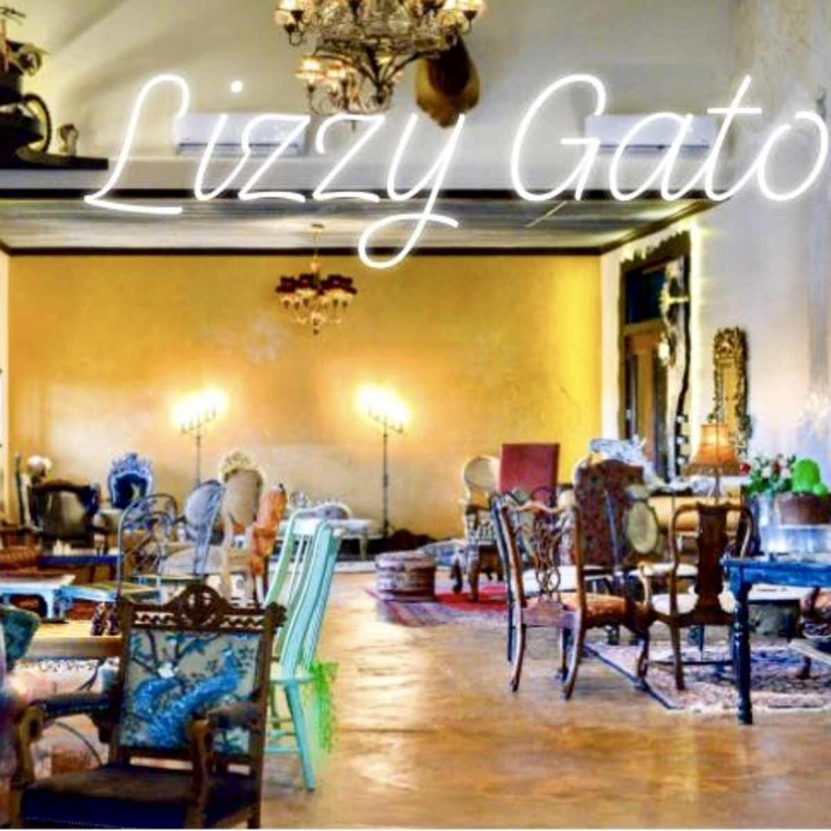 A decorated interior space with various antique chairs and decorative elements, labeled "Lizzy Gator" in neon text.