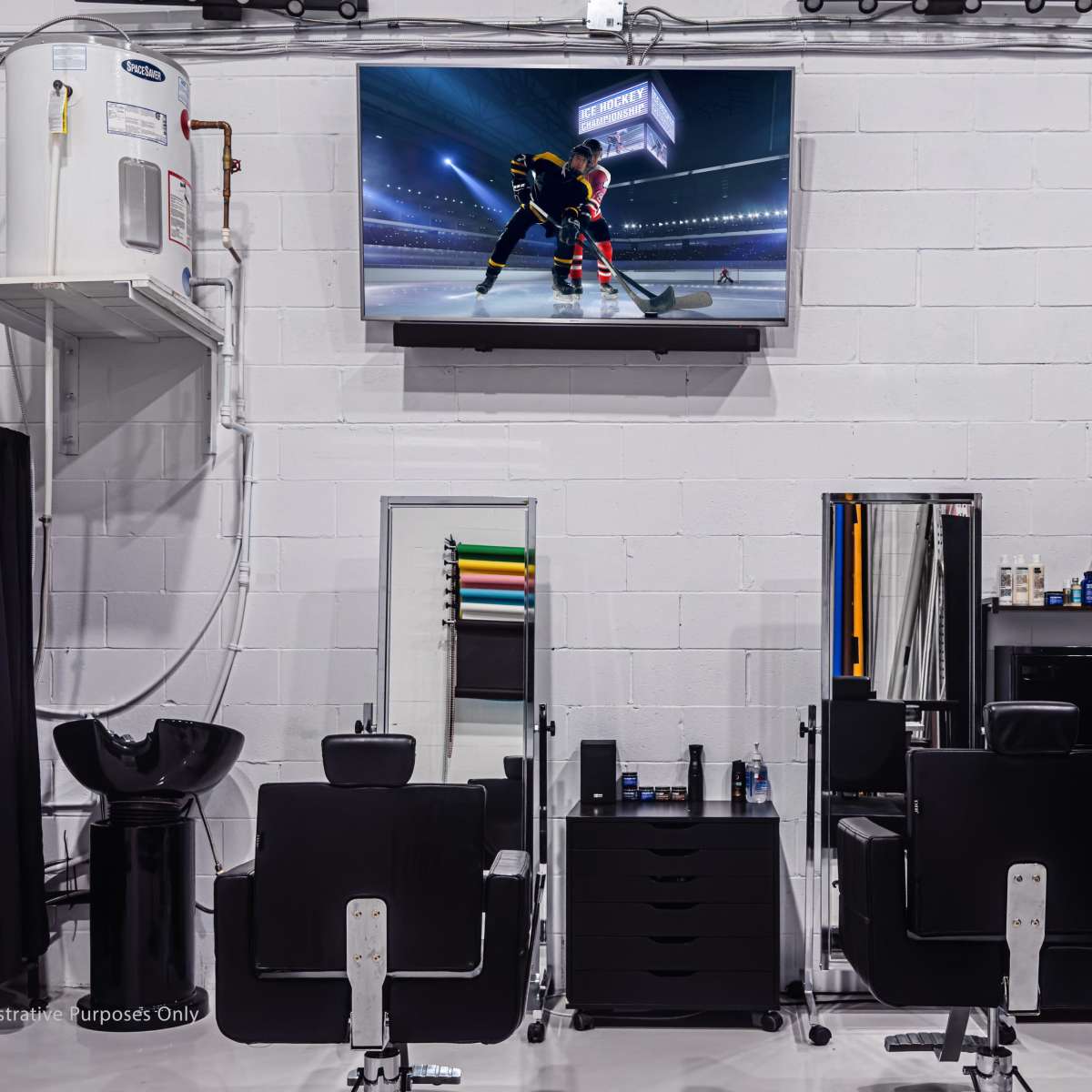 A modern hair salon with several styling stations, a large television displaying a hockey game, and a wall-mounted sink.