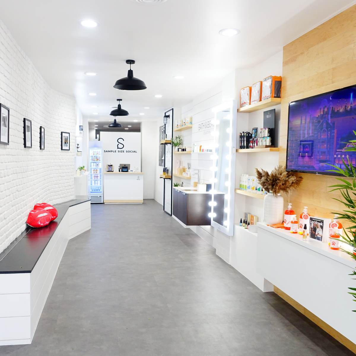 A modern skincare store interior with white brick walls, sleek display shelves, and a reception area in the background.