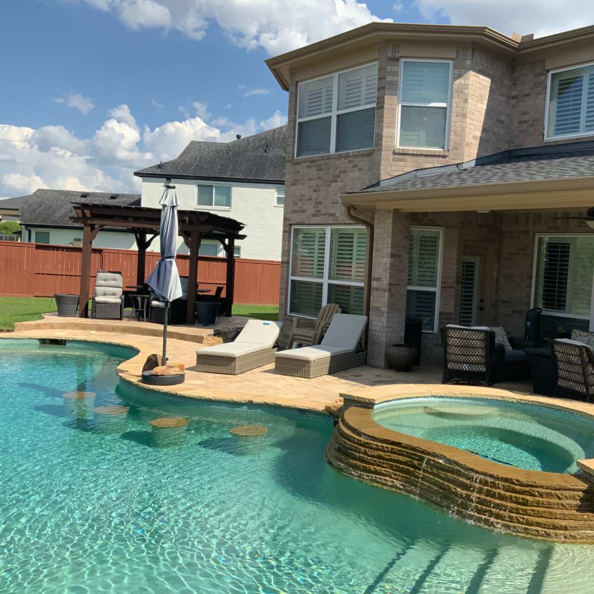 Tropical Style With Beach Entry Swimming Pool In a Large Backyard