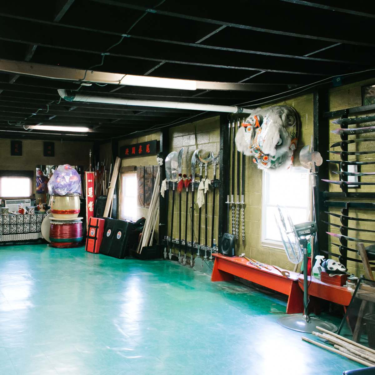 A spacious room filled with various traditional performance costumes and instruments arranged along the walls.