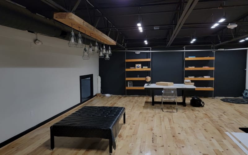 Modern/industrial studio space with wood flooring located near IAH