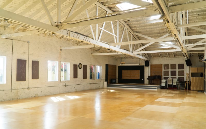Warehouse Dance Studio with Brick Walls, Wood Floors and Front Stage