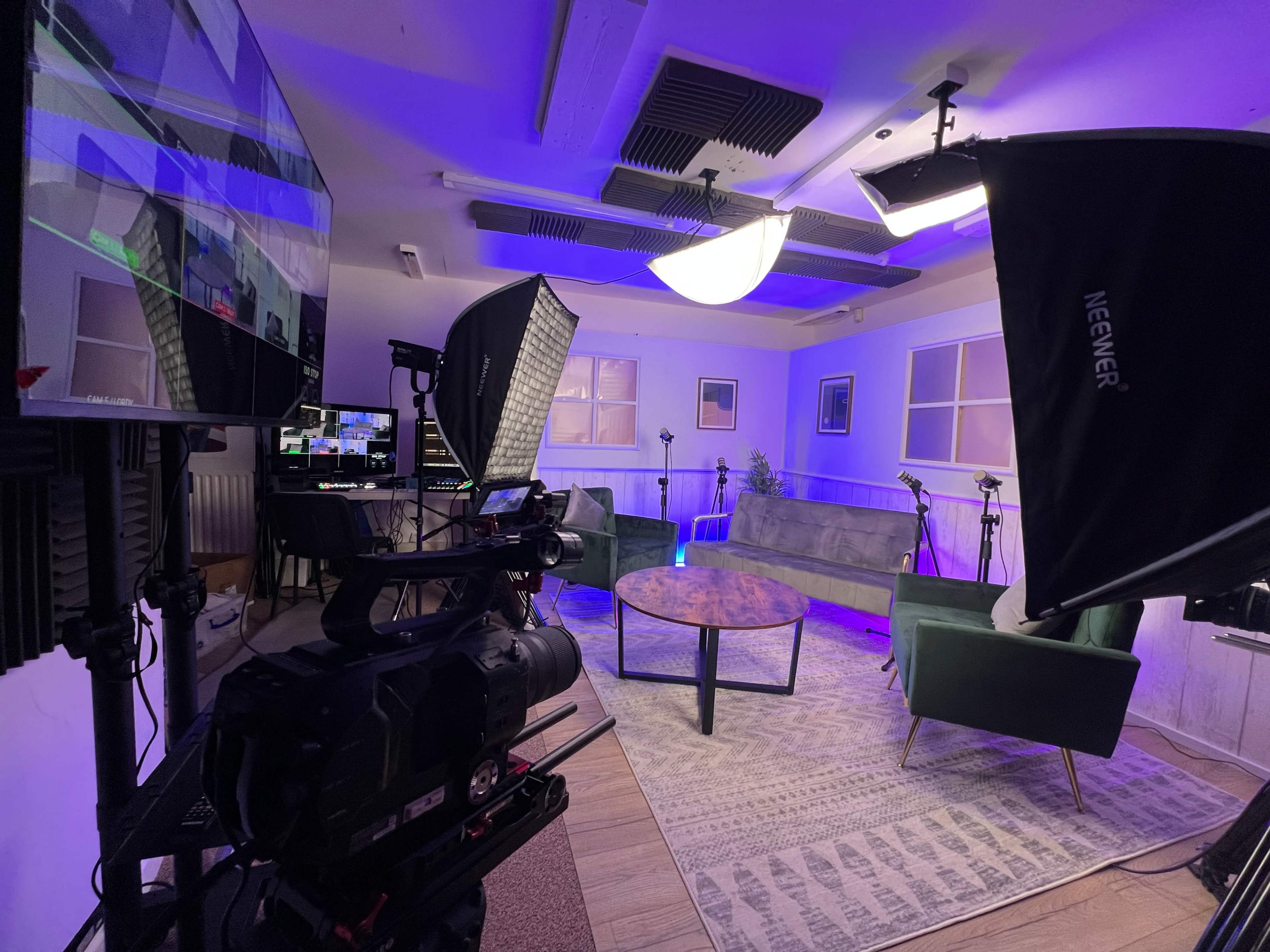 Red Branch Studios podcast set with sofa, armchair and microphones