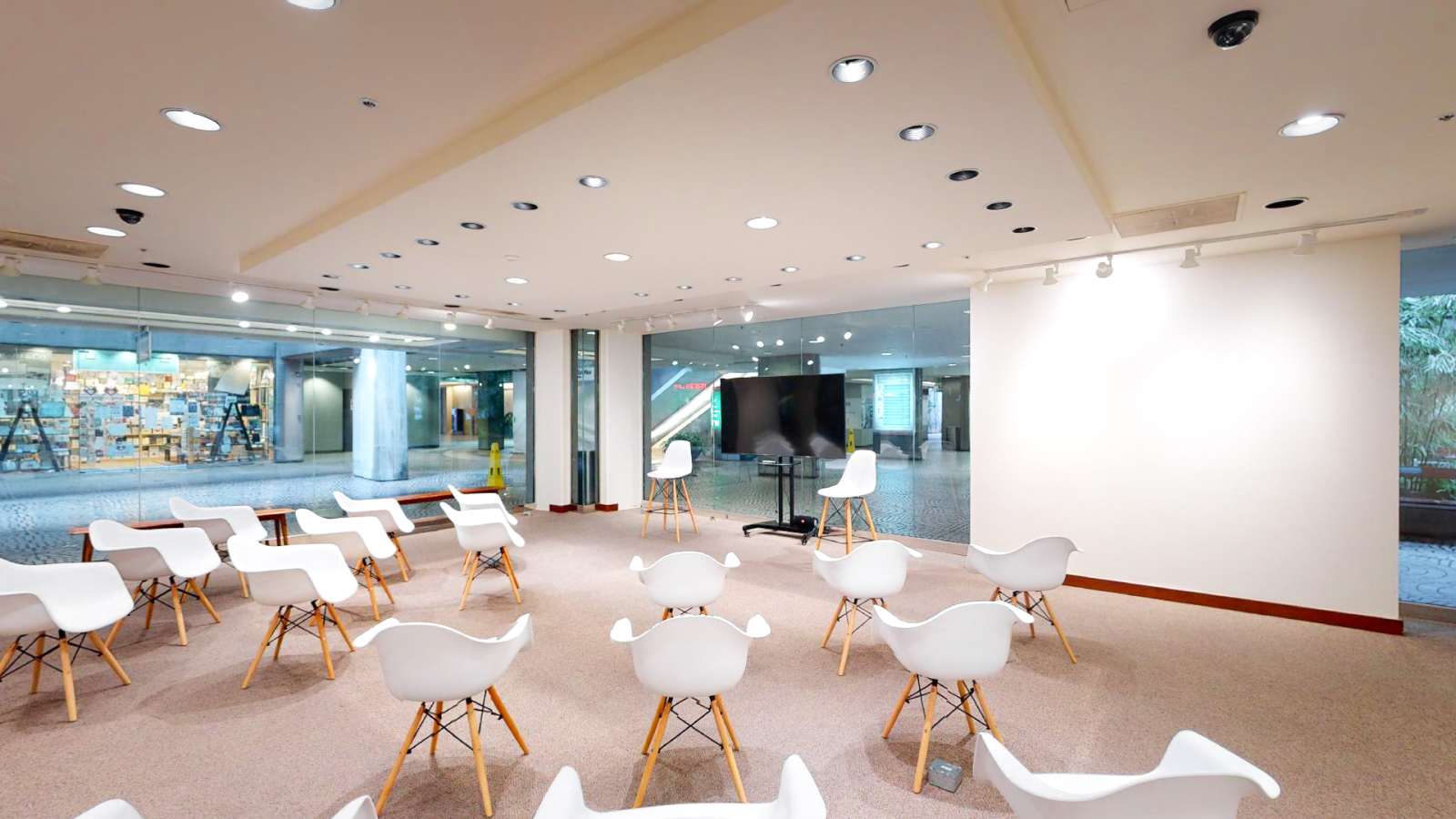 Spacious presentation room with semicircle seating and a large screen