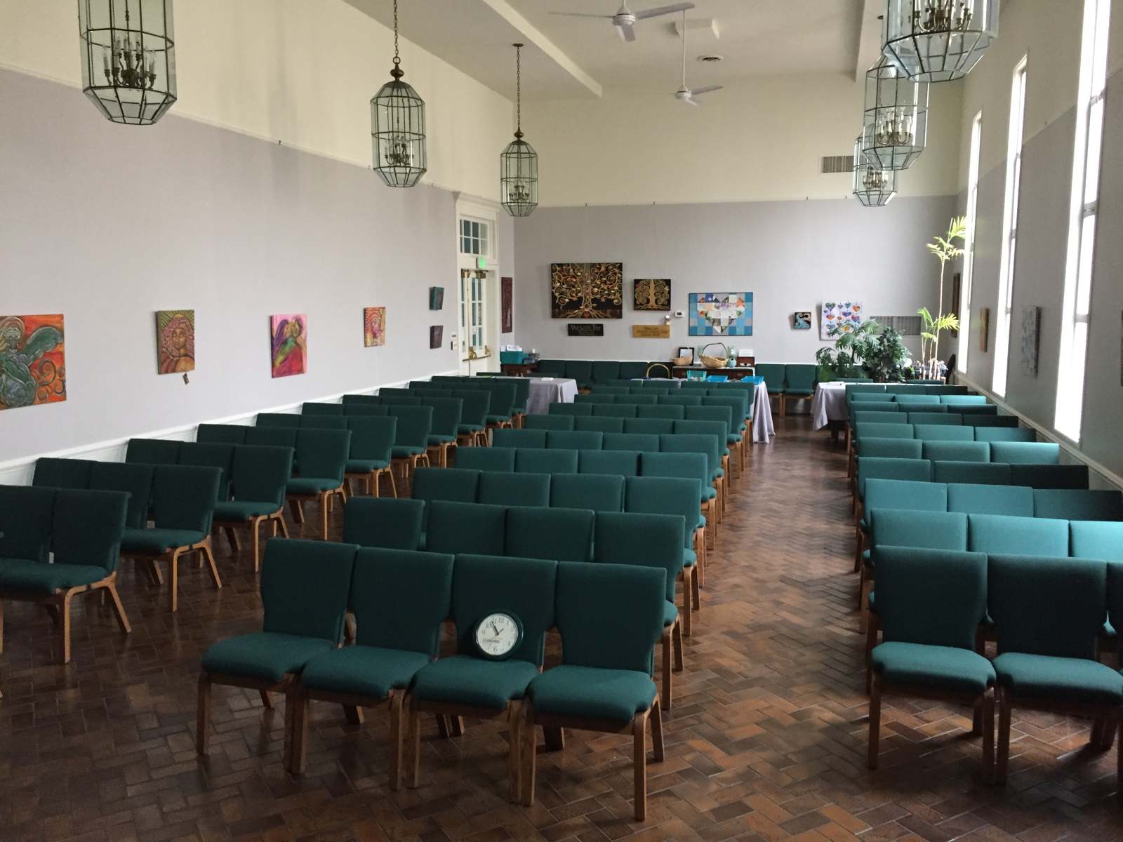 Spacious Lakeside hall with rows of teal chairs and artwork