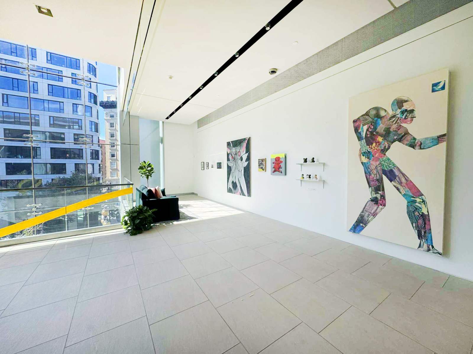 Bright modern art gallery with colorful work and large windows