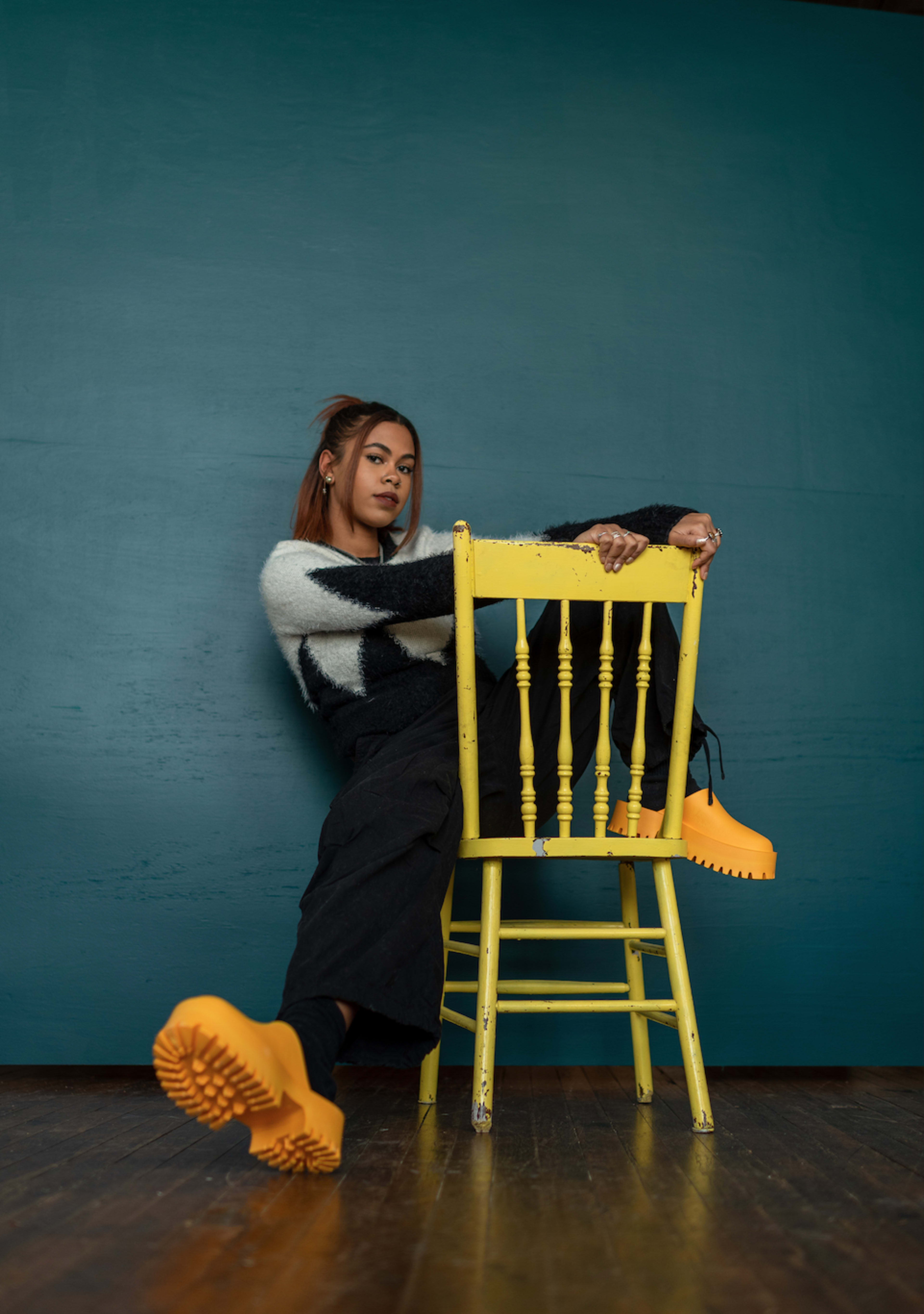 A woman sitting on a yellow chair .
