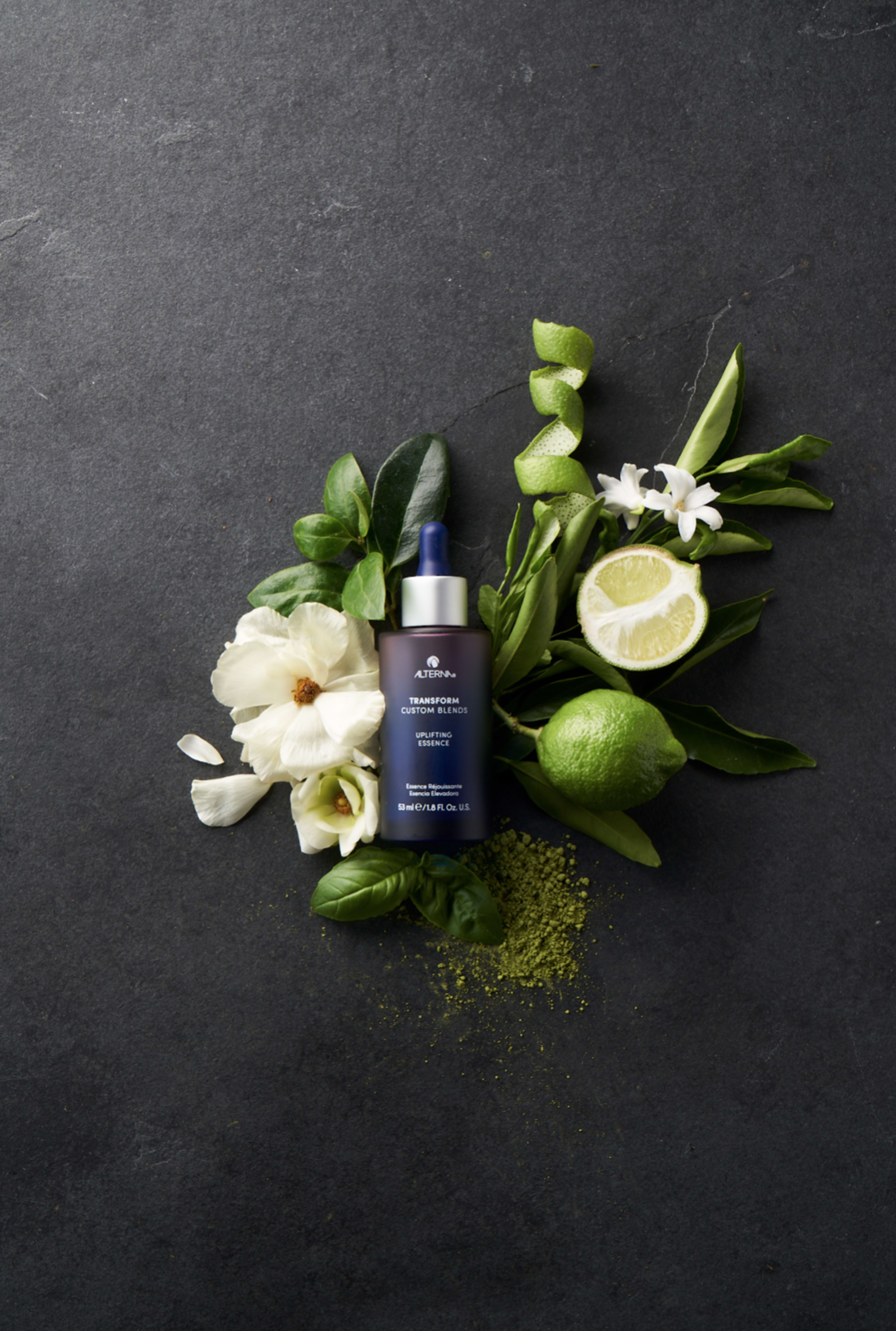 A product photoshoot featuring skin care, lime, and flowers.