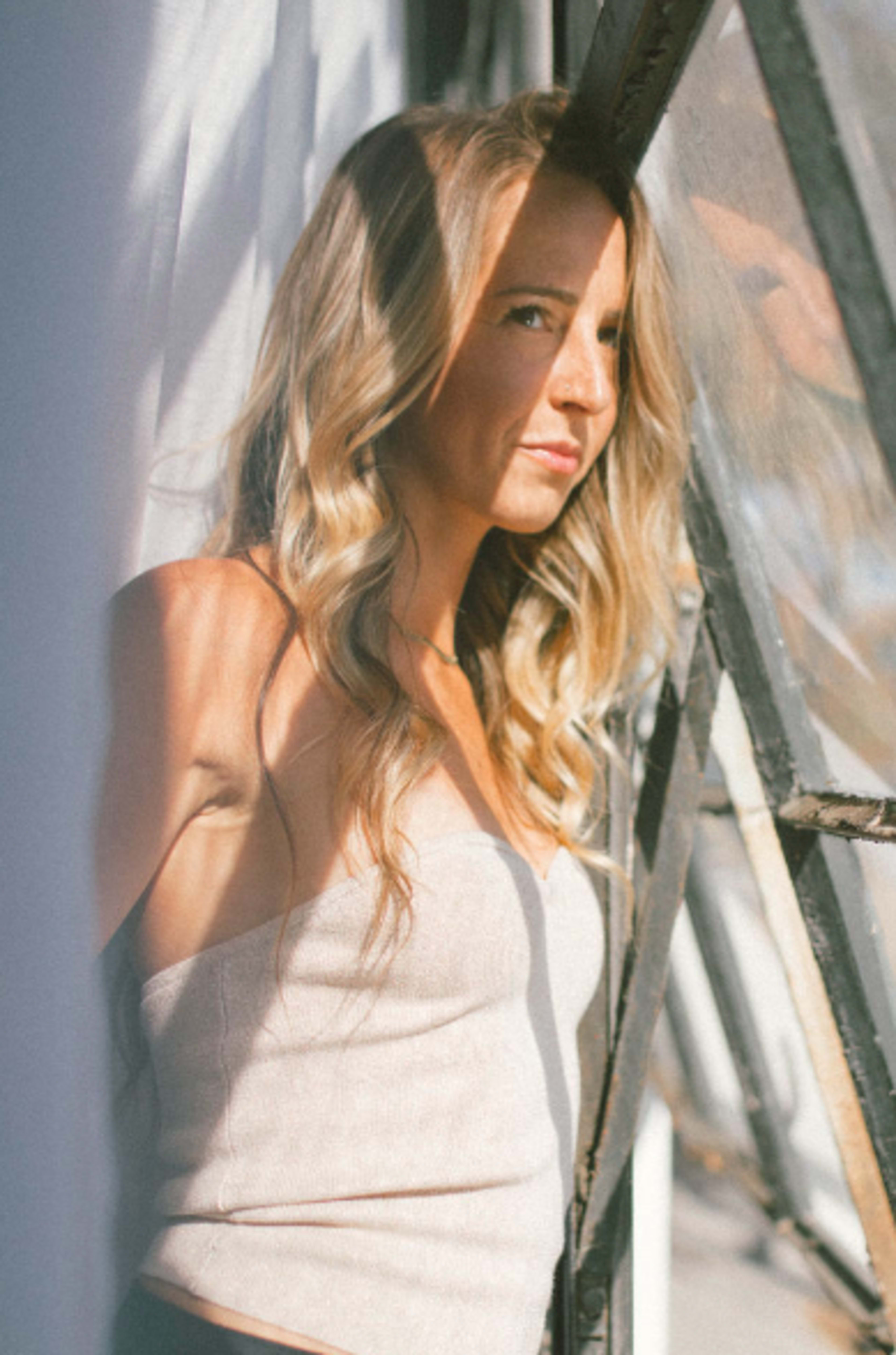 A woman leaning against a wall.