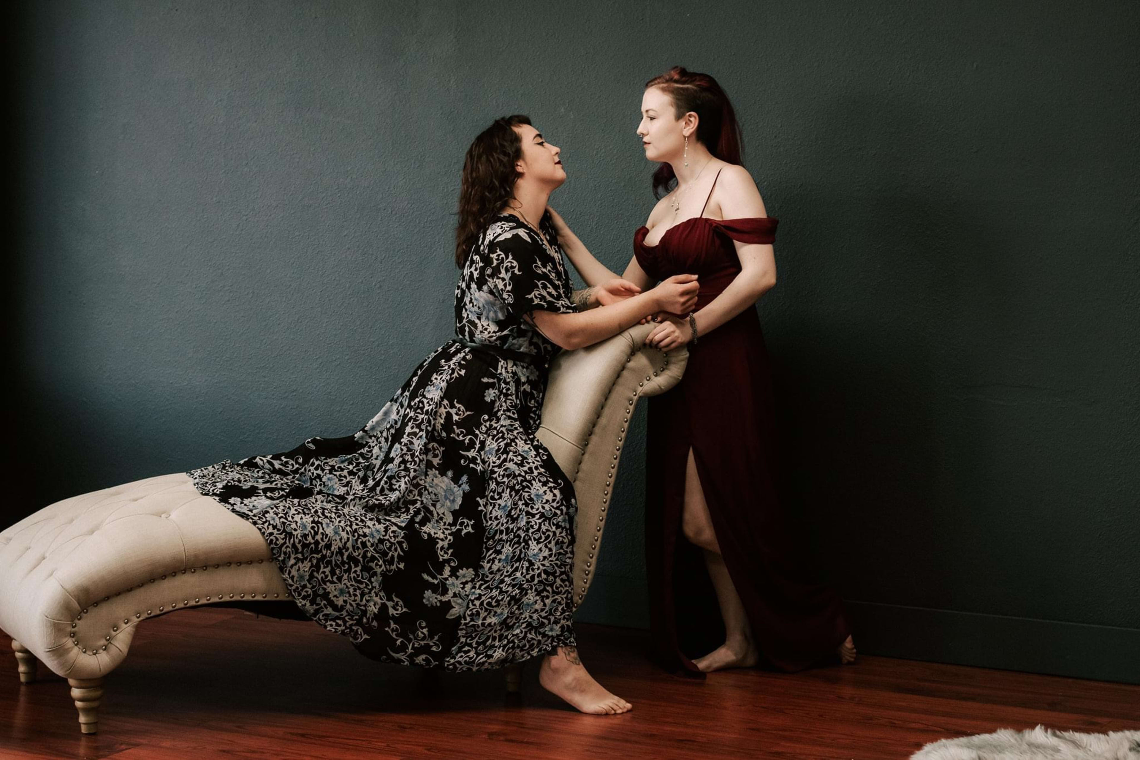 Two women are posing in a photoshoot.