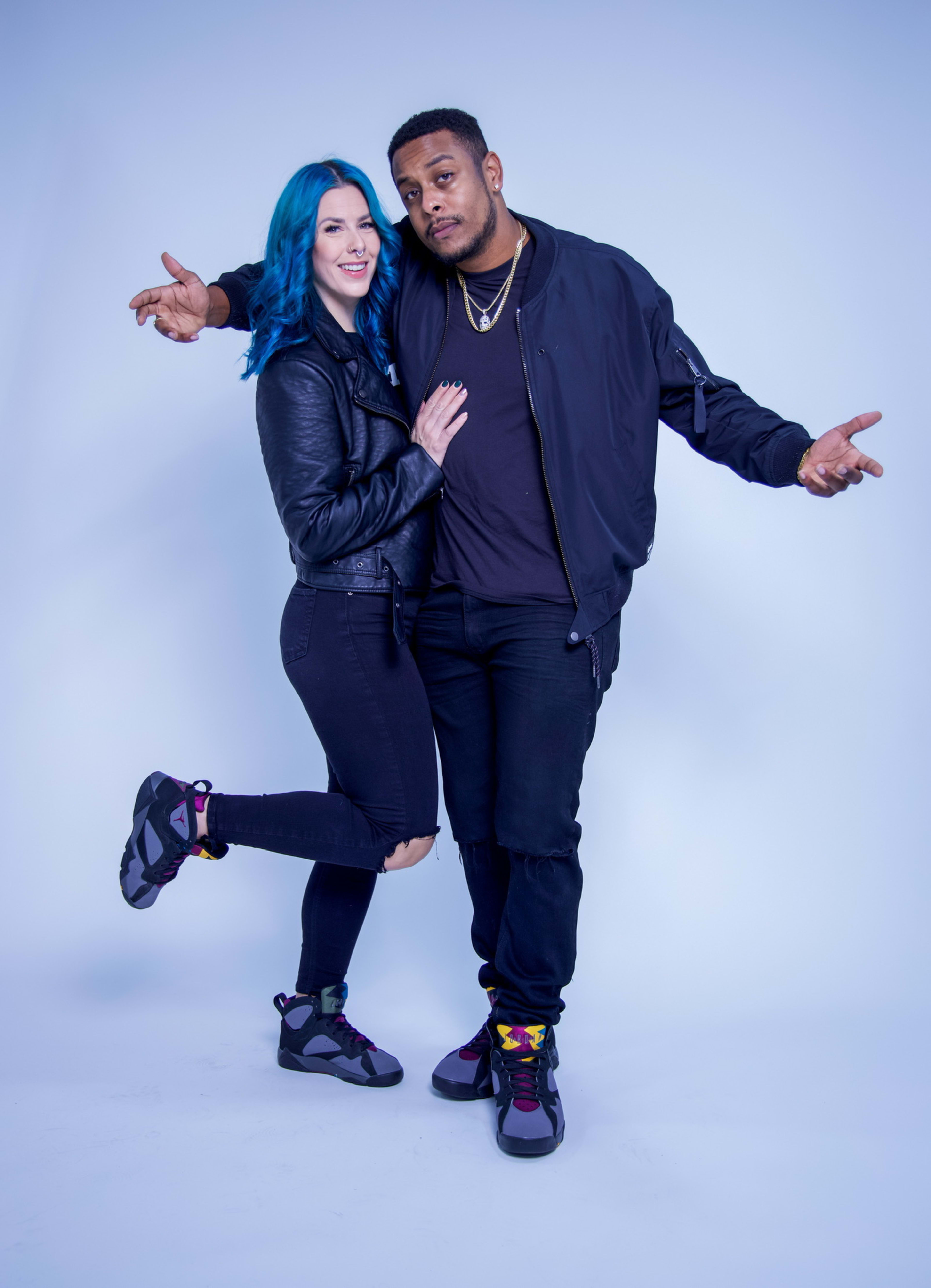 A blue-haired woman and a man posing for a photo shoot picture.