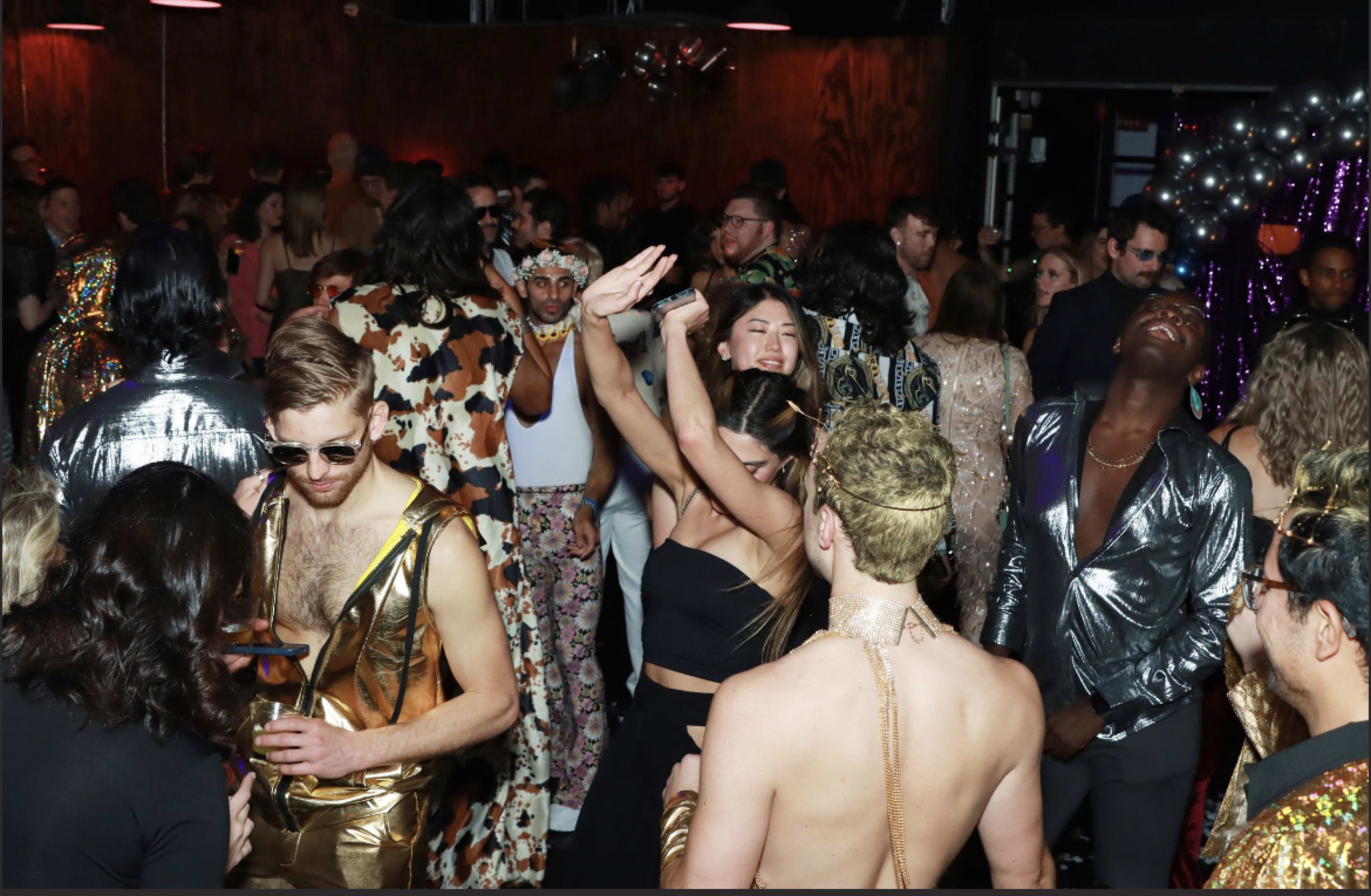 A group of people dancing at a disco party.