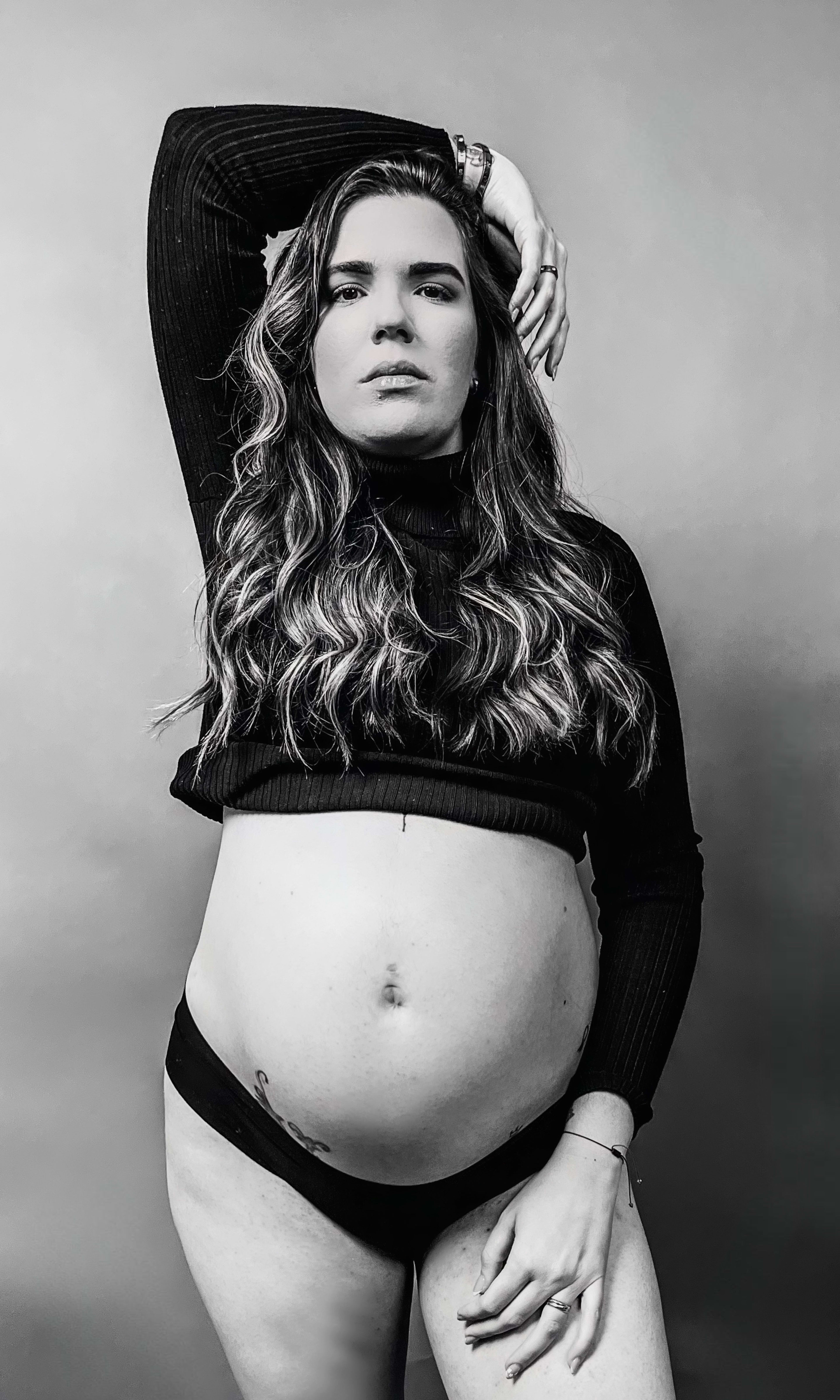 A black and white maternity photo shoot of a pregnant woman.