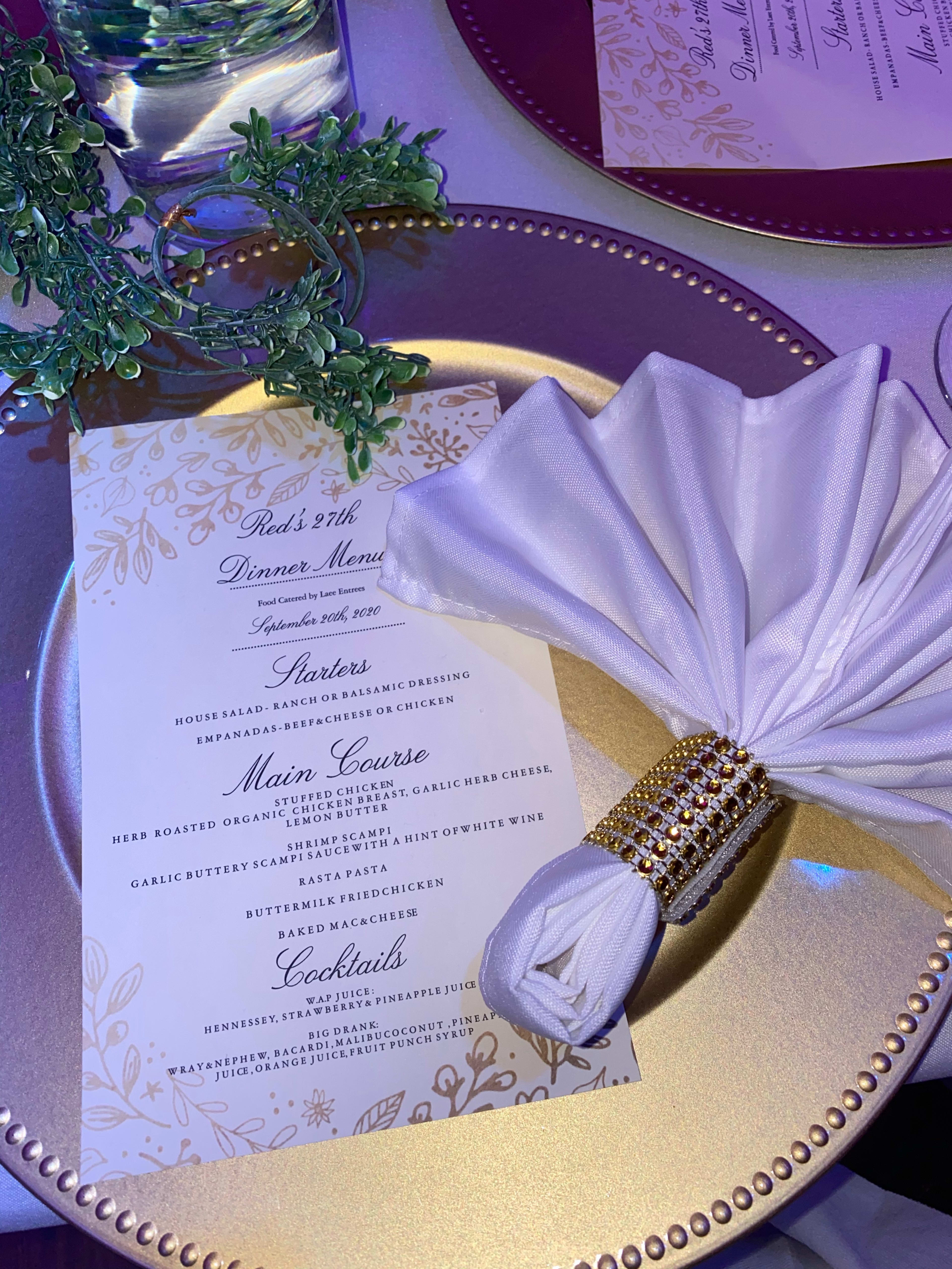 A purple and white dinner party table setting with a menu and napkin.
