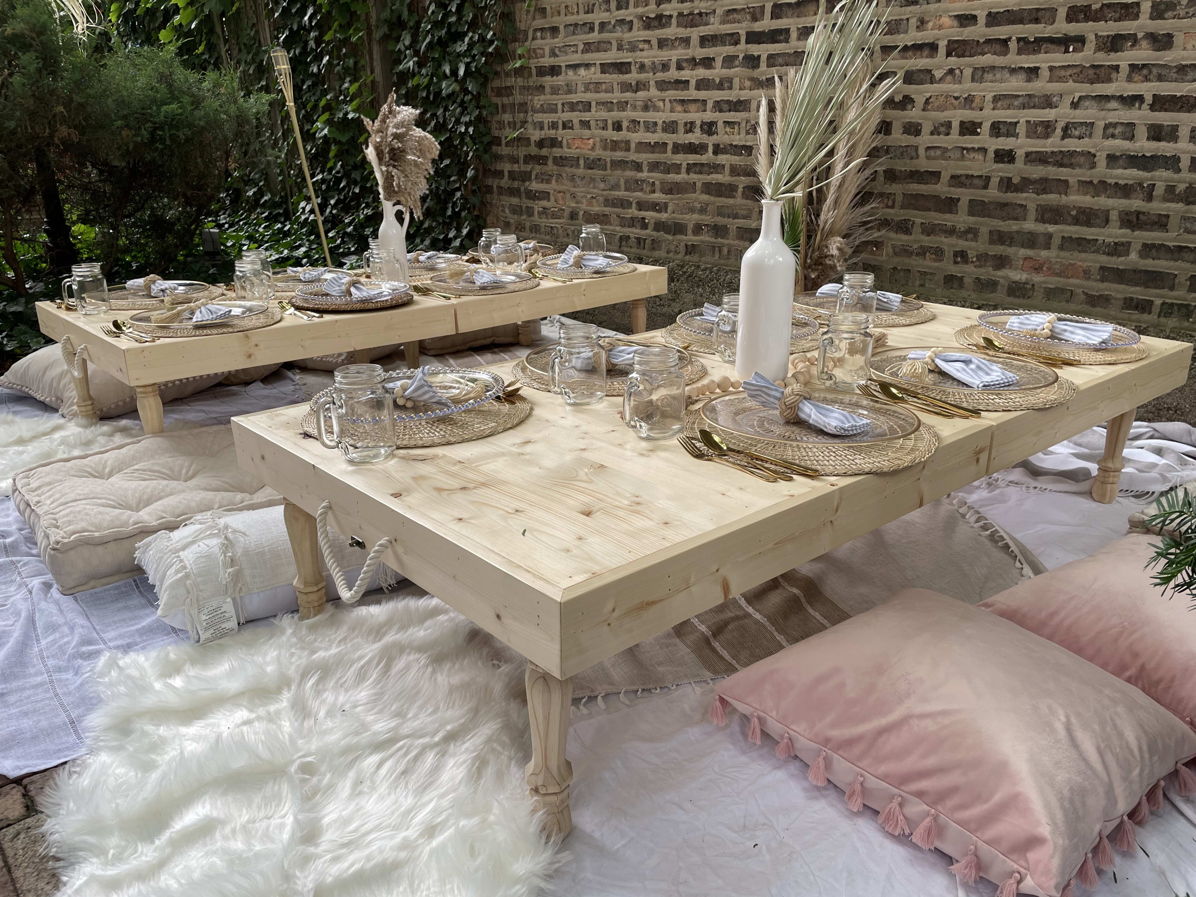 A boho-themed bridal shower table set up with beige plates and place settings.