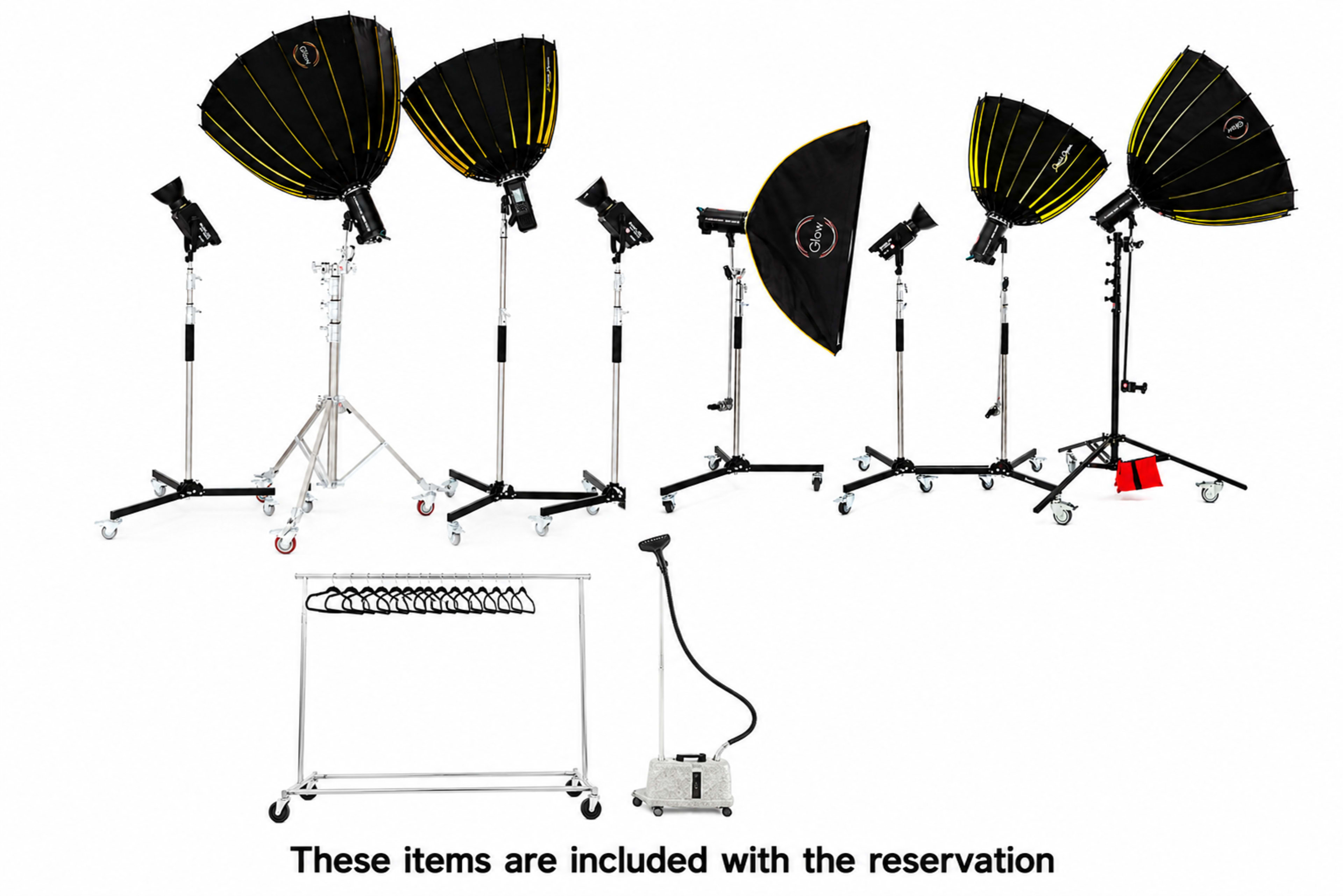 The image shows a collection of studio lighting equipment, including multiple light modifiers, stands, and a hanging rack for accessories.