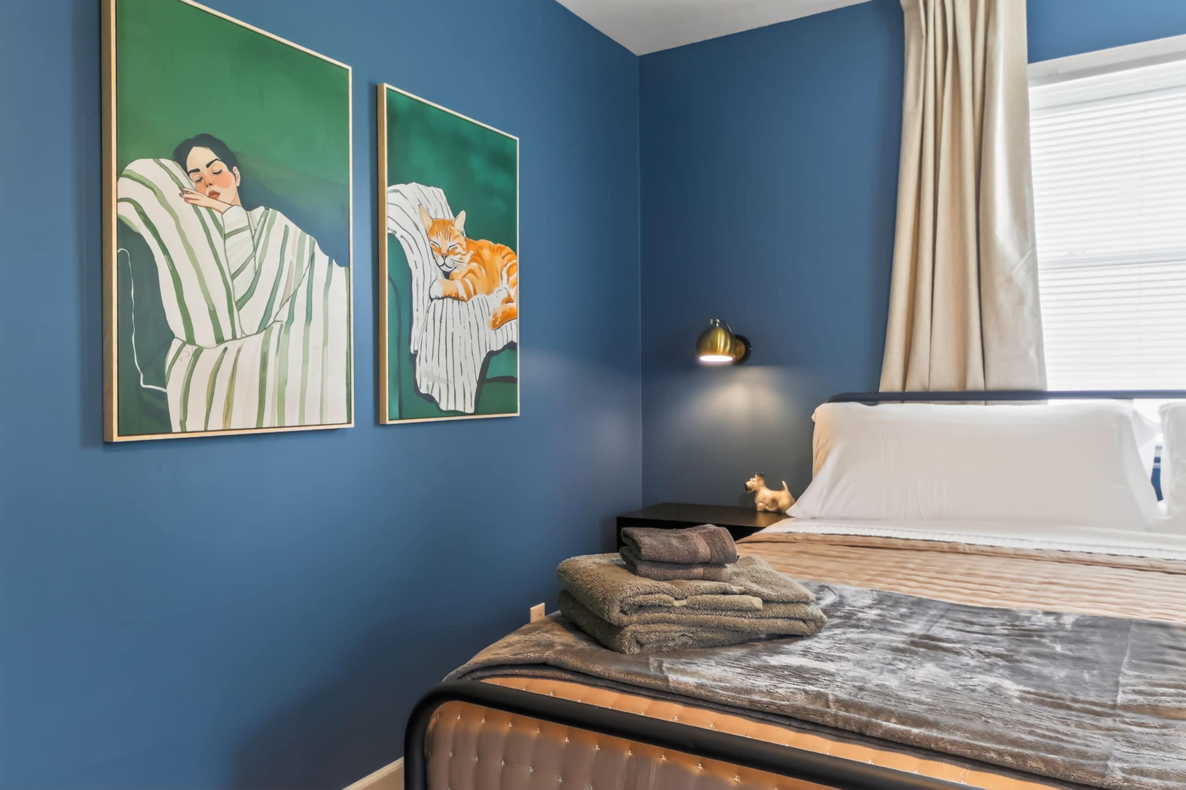 Moody Navy-Walled Bungalow with Bold Art & Backyard Image in Blue Township, Independence, MO