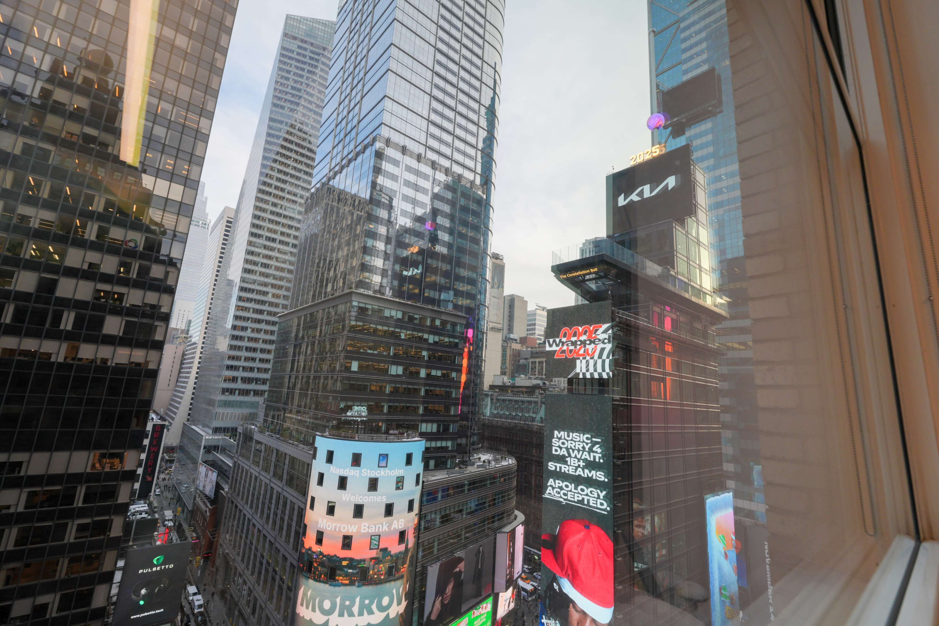 The image shows a view of Times Square in New York City, filled with tall buildings and illuminated advertisements.