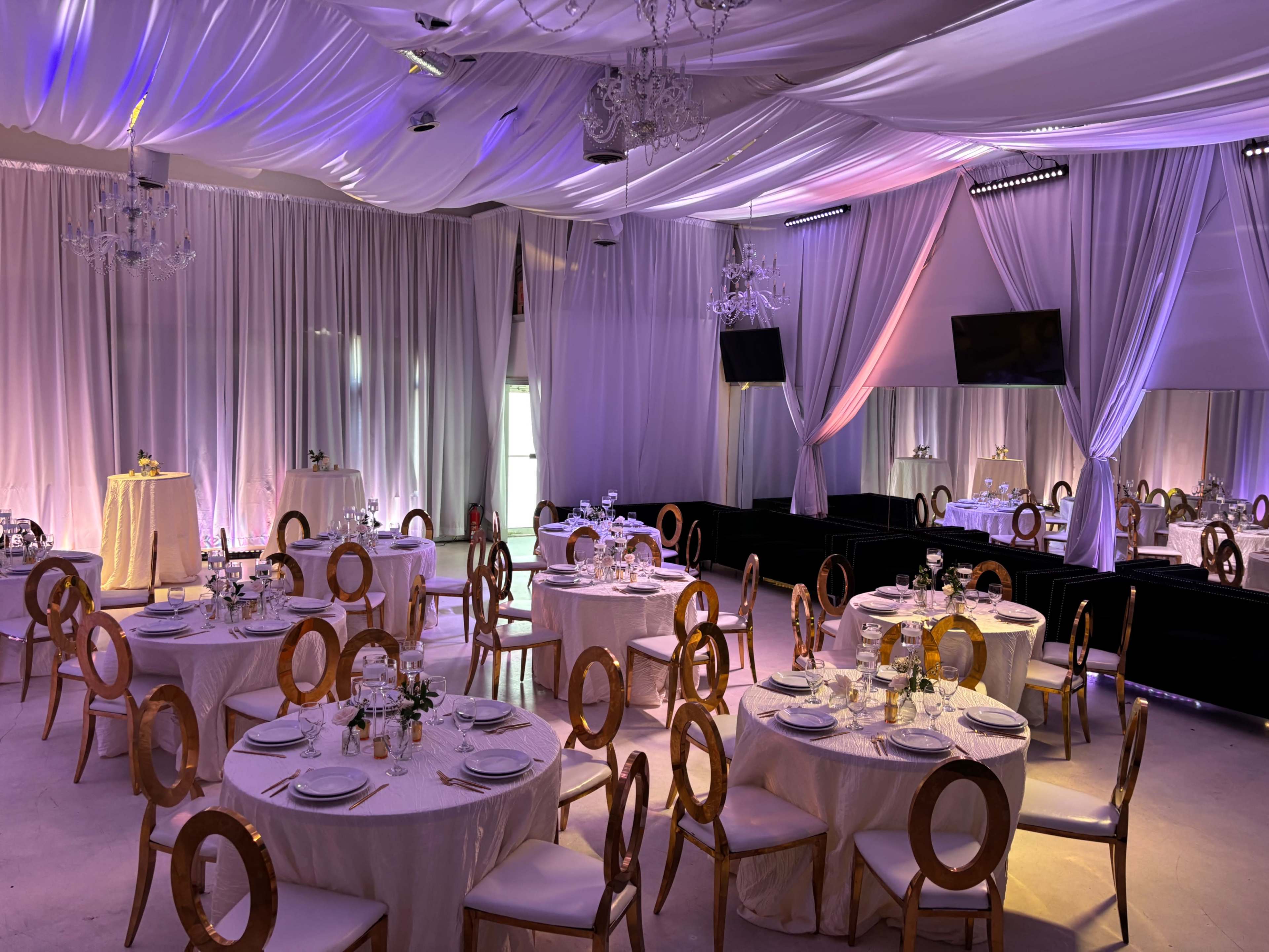 Fully Draped Midtown Lounge & Dinner Party Room with Chandeliers and Uplighting Image in Buckhead, Atlanta, GA