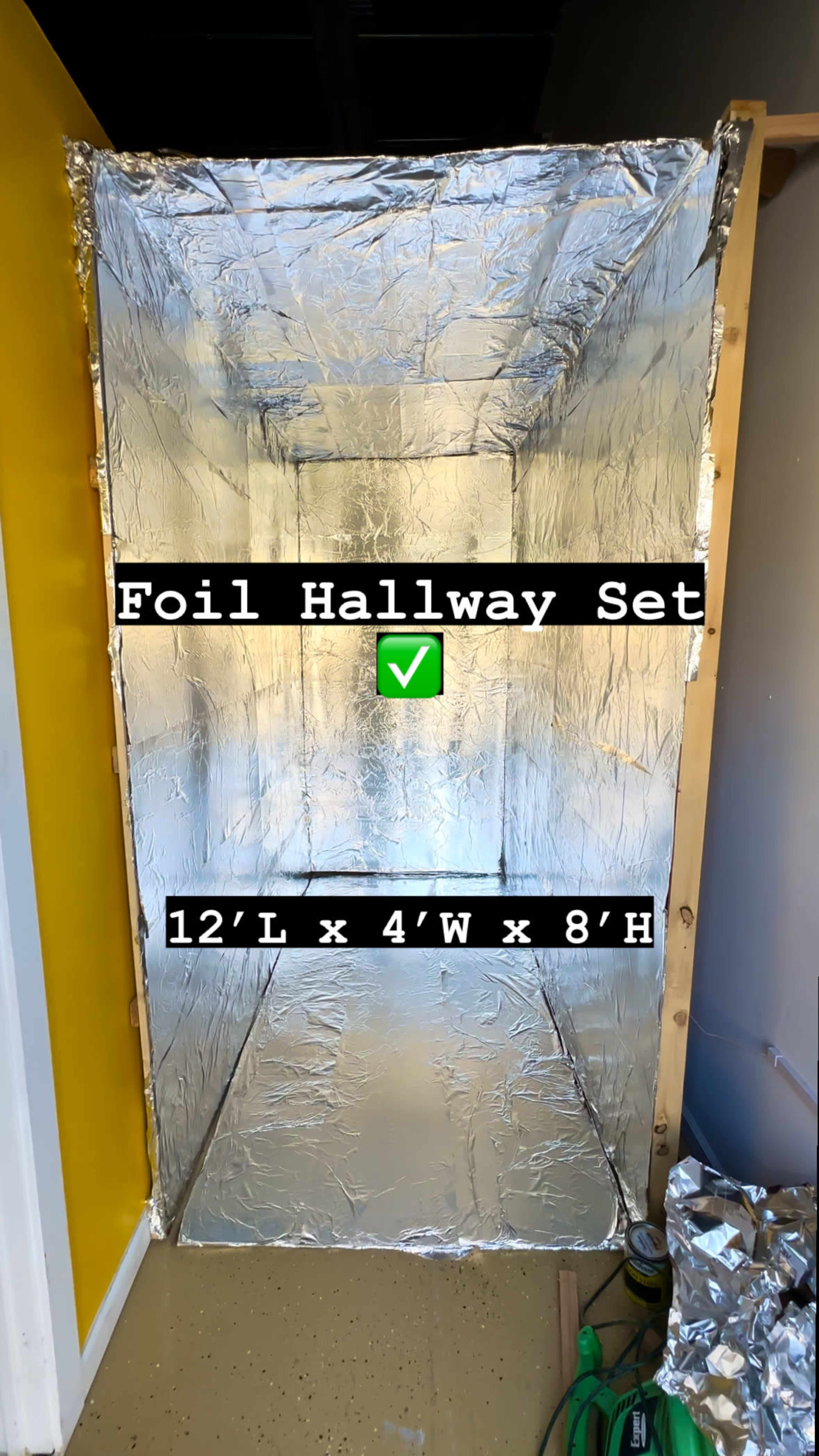 A hallway set covered in silver foil, measuring 12 feet long, 4 feet wide, and 8 feet high.