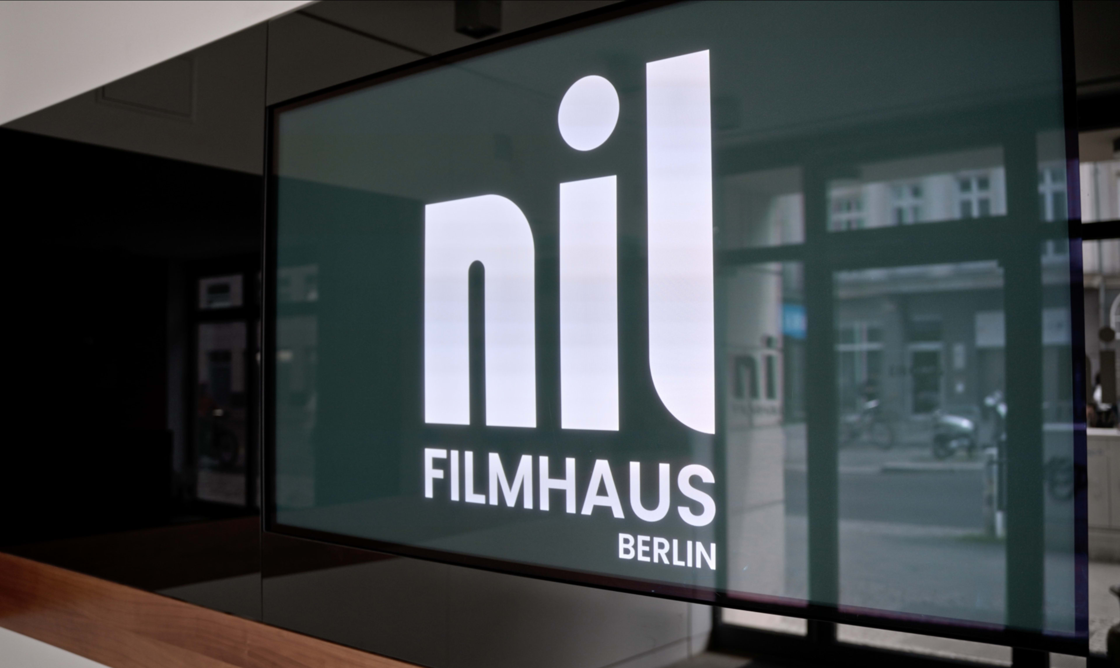 The image shows a digital display featuring the logo of "nil FILMHAUS" alongside the word "Berlin."