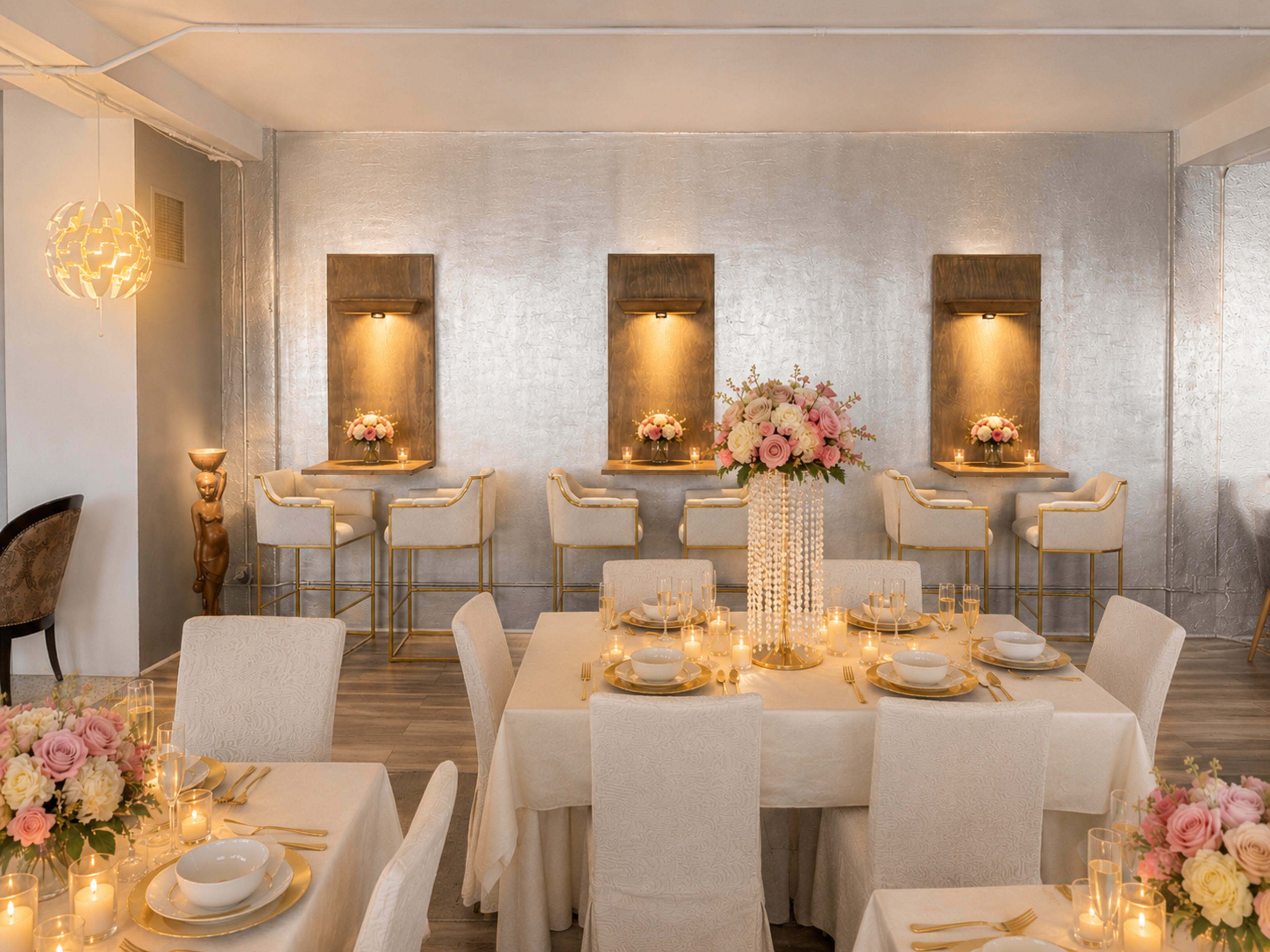 The image shows an elegantly arranged dining area with decorated tables, soft lighting, and floral centerpieces.