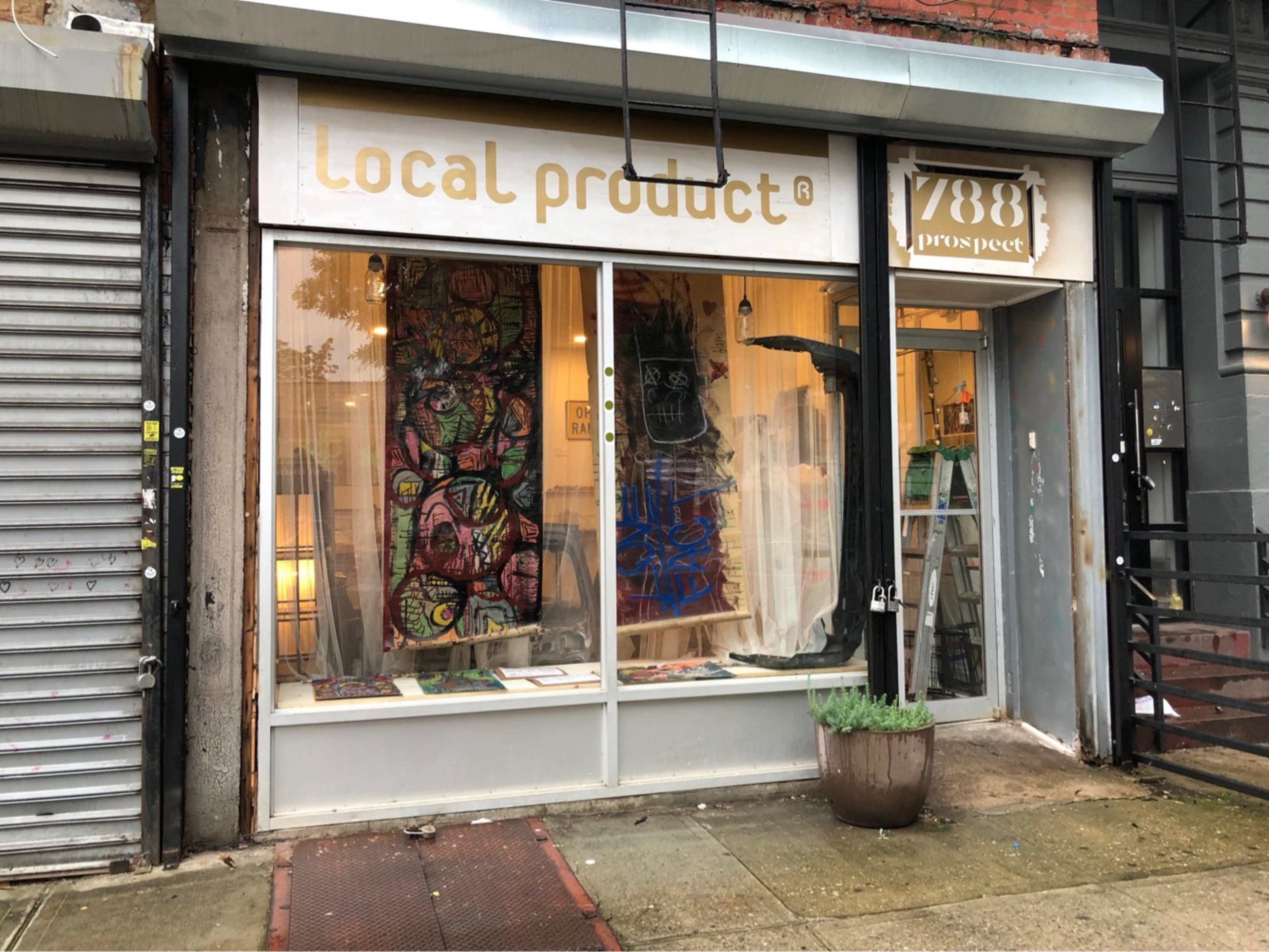 The storefront features large windows displaying colorful artwork and a sign reading "Local Product" at 788 Prospect.
