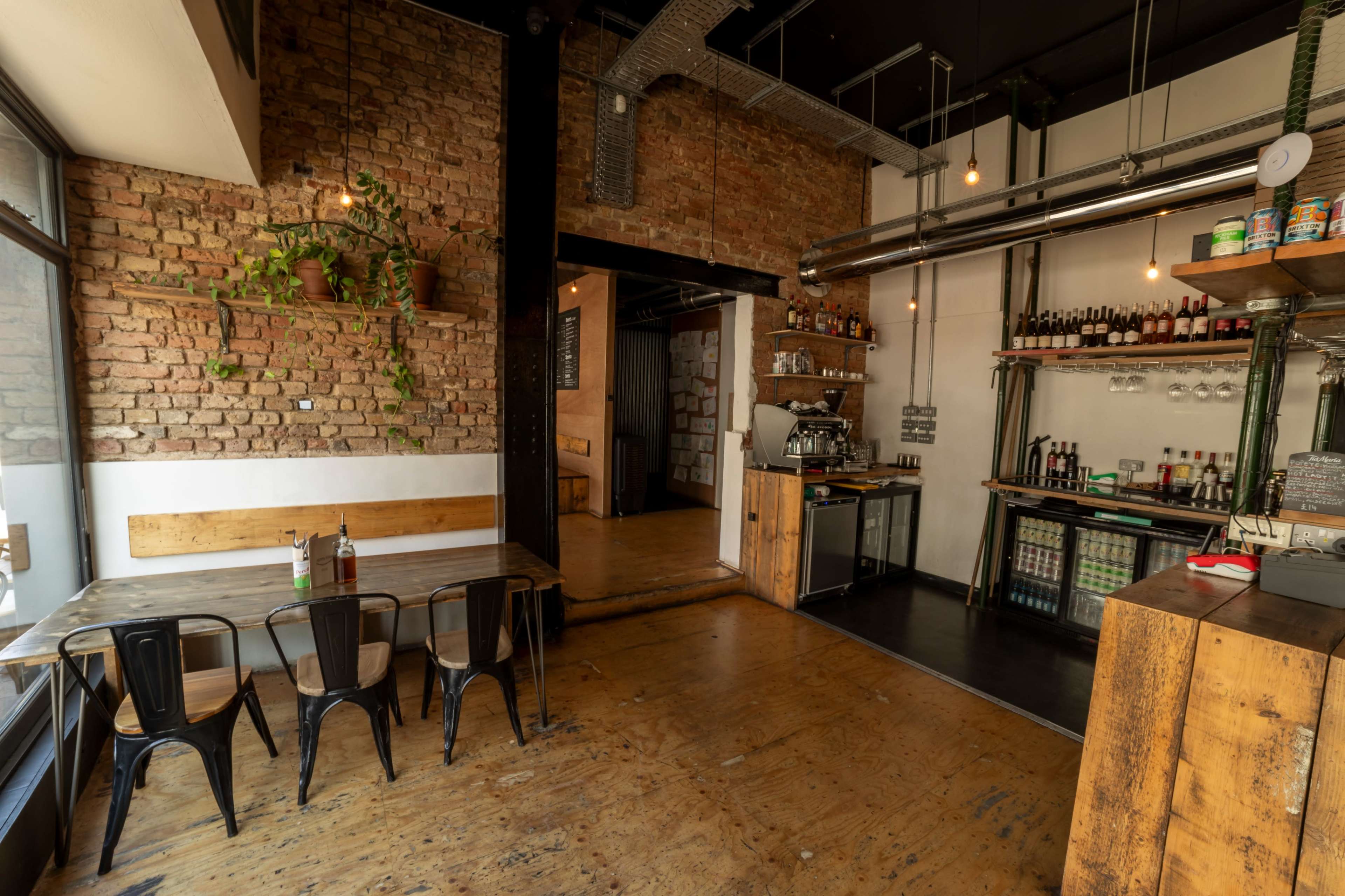 Rustic pizza restaurant with high ceilings and windows spanning the venue. Image in South Norwood, London, ENG