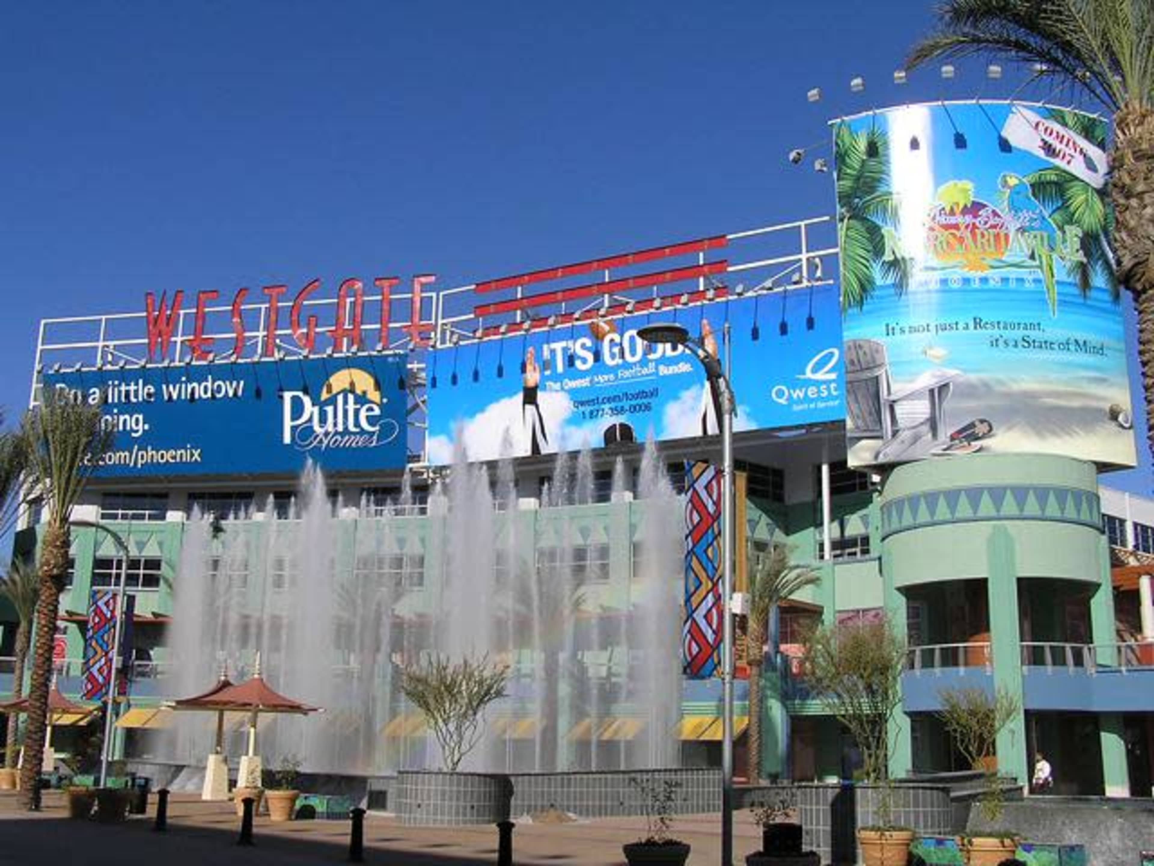 The Westgate complex features a multi-story building with colorful advertisements and a fountain in the foreground.
