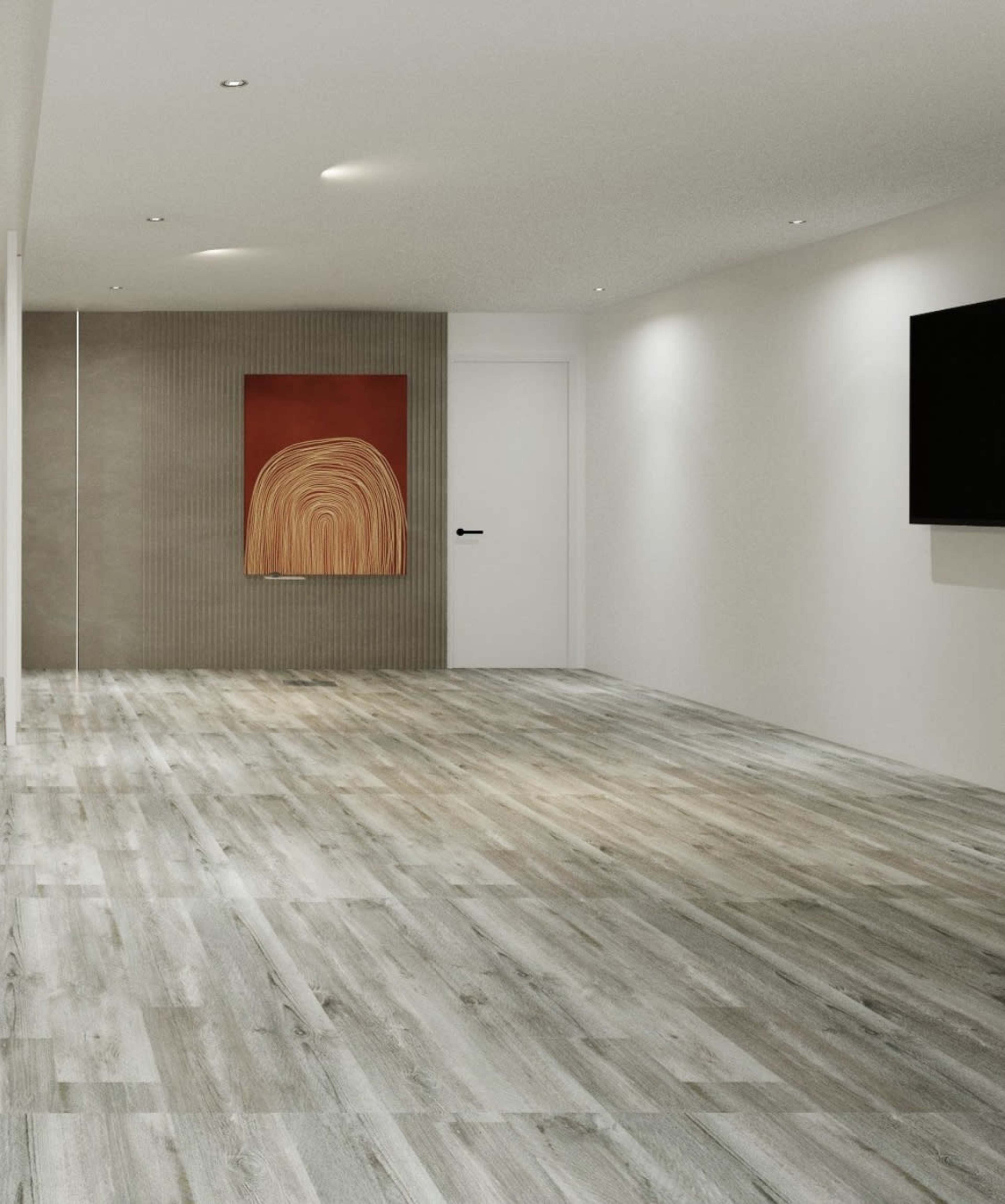 A spacious, minimalist room with wooden flooring, a wall-mounted television, and an abstract painting on the wall.
